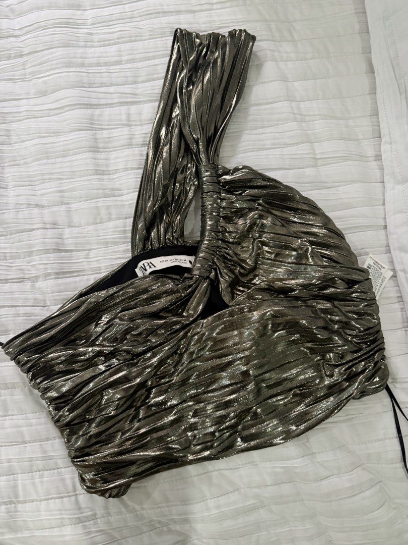 Zara Metallic One Shoulder Crop Top (Category: Sleeveless) located in Quezon City. Submitted by afternoonstore (Listing ID 1466842207, Image 1). Description: - Brand: Zara - Style: Metallic one-shoulder crop top with unique gathered strap - Color: Gunmetal grey with textured pleats - Size: XS - Condition: Like new (worn once for a short event) - Environment: Smoke-free home - Ideal for: Parties and night outs.