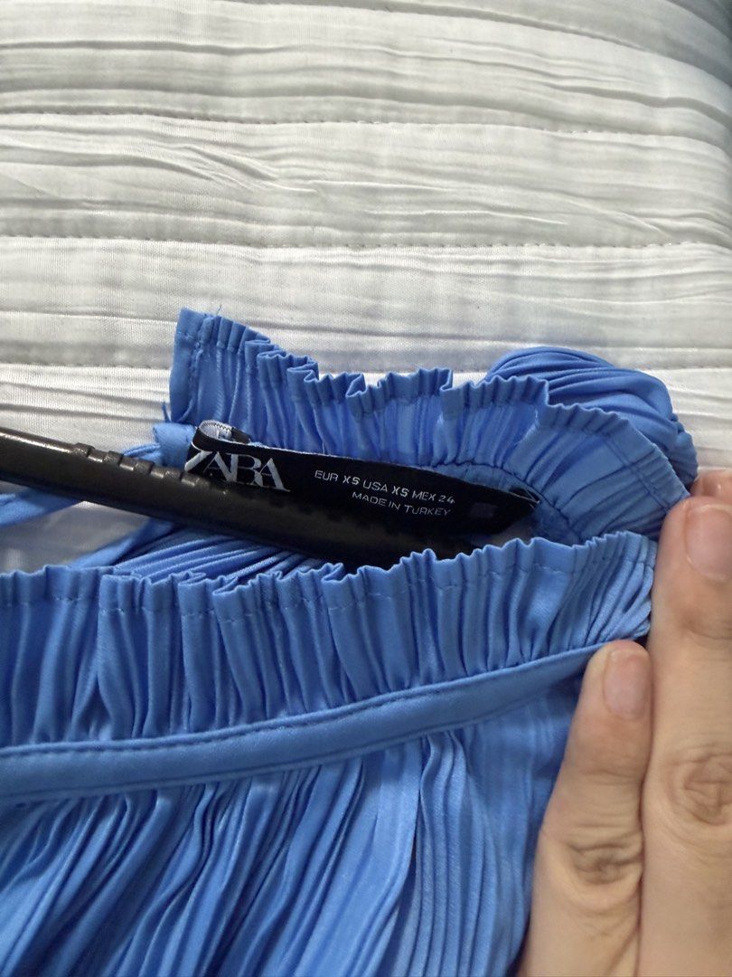 Zara Pleated Blue Sleeveless Blouse XS (Category: Sleeveless) located in Quezon City. Submitted by afternoonstore (Listing ID 1466844591, Image 2). Description: - Brand: Zara - Size: XS (fits true to size) - Color: Bright blue - Design: All-over pleats, high neckline with ruffled collar - Origin: Made in Turkey - Condition: Clean, worn only a couple of times - Ideal for: Summer wear or layering under blazers.