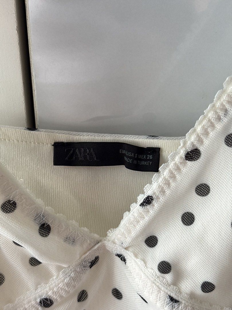 Zara Polka Dot Mesh Camisole Top (Category: Sleeveless) located in Manila. Submitted by jodi.declutters (Listing ID 1466784203, Image 3). Description: - Brand: Zara - SRP 1395 - Size: S (True to size) - Color: White with black polka dots - Material: Sheer mesh - Details: Adjustable spaghetti straps, sweetheart neckline, delicate scalloped lace trim - Origin: Made in Turkey - Style: Perfect for layering or wearing on its own.
