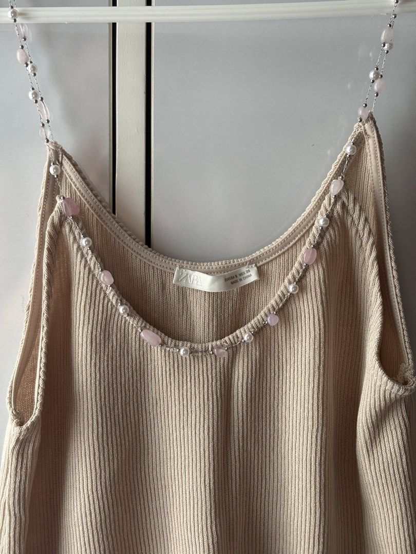 Zara Ribbed Beaded Top (Category: Sleeveless) located in Manila. Submitted by jodi.declutters (Listing ID 1466784191, Image 2). Description: - Brand: Zara - Never Used - SRP 1795 - Style: Ribbed knit tank top - Color: Beige - Size: S (fits true to size) - Details: Beaded straps with faux pearls and pink stones - Fabric: Lightweight and stretchy - Condition: Worn just a couple of times, still in great shape.