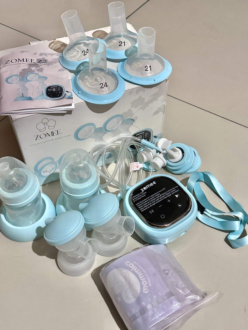 Zomee Z2 Double Electric Breast Pump Full Set (Category: Breastfeeding & Bottle Feeding) located in Manila. Submitted by catianafeliciano (Listing ID 1466926658, Image 1). Description: - Zomee Z2 double electric breast pump setup - Includes main pump unit and tubing - Comes with milk collection bottles and storage bags - Includes flanges in both 21mm and 24mm sizes - Complete with manual and original box - Everything is clean, complete, and ready