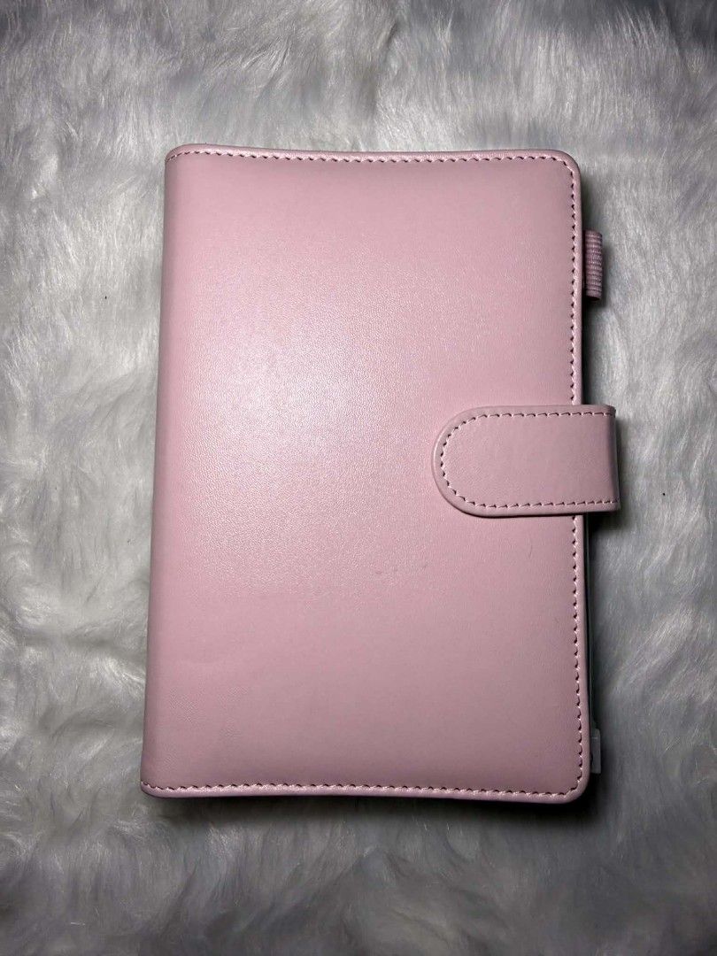 A6 Pink Binder Organizer with Cash Envelopes (Category: Stationery & School Supplies) located in Manila. Submitted by abcdcv (Listing ID 1419126043, Image 1). Description: - A6 Pink binder organizer - With free ballpen‼️ - With free 12 snap closure envelopes - Ring binder mechanism - Clear pockets for organization - Smooth, solid pink exterior - Compact size.