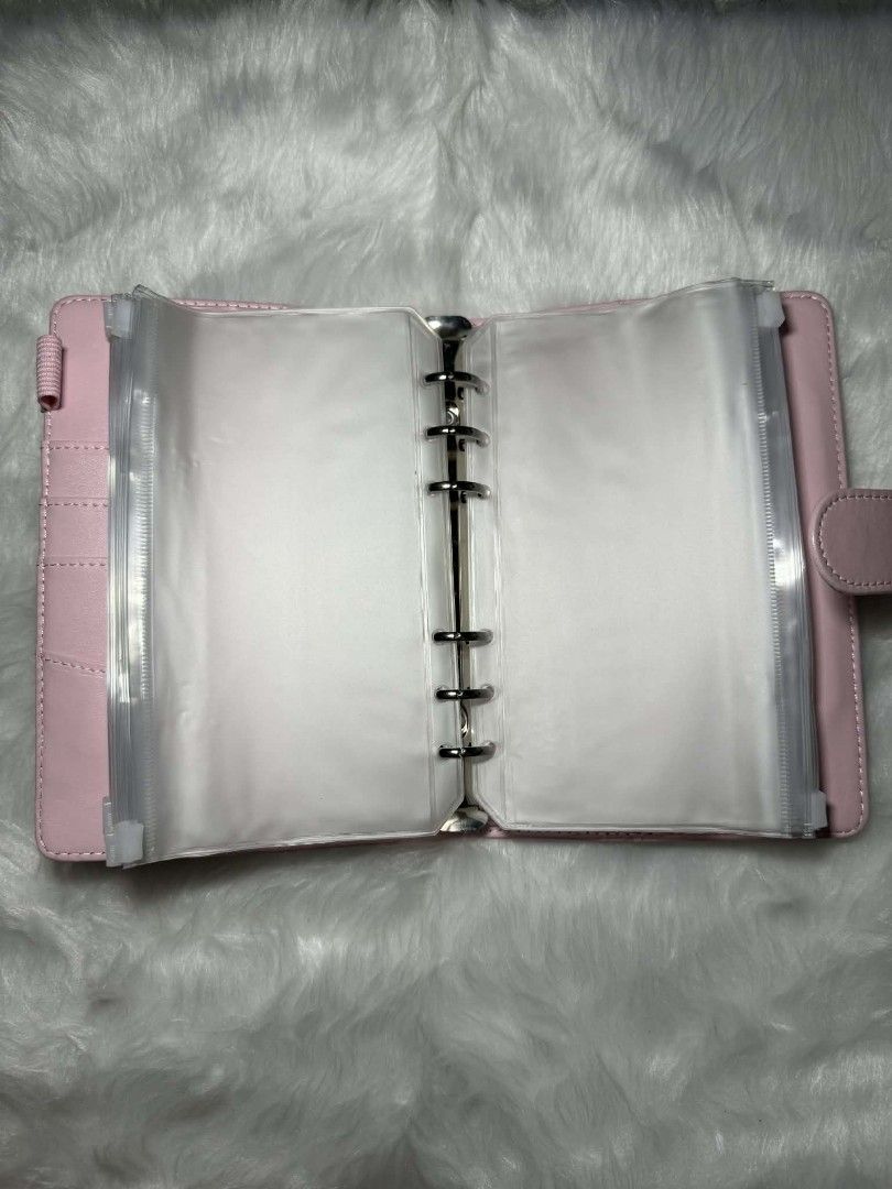 A6 Pink Binder Organizer with Cash Envelopes (Category: Stationery & School Supplies) located in Manila. Submitted by abcdcv (Listing ID 1419126043, Image 2). Description: - A6 Pink binder organizer - With free ballpen‼️ - With free 12 snap closure envelopes - Ring binder mechanism - Clear pockets for organization - Smooth, solid pink exterior - Compact size.