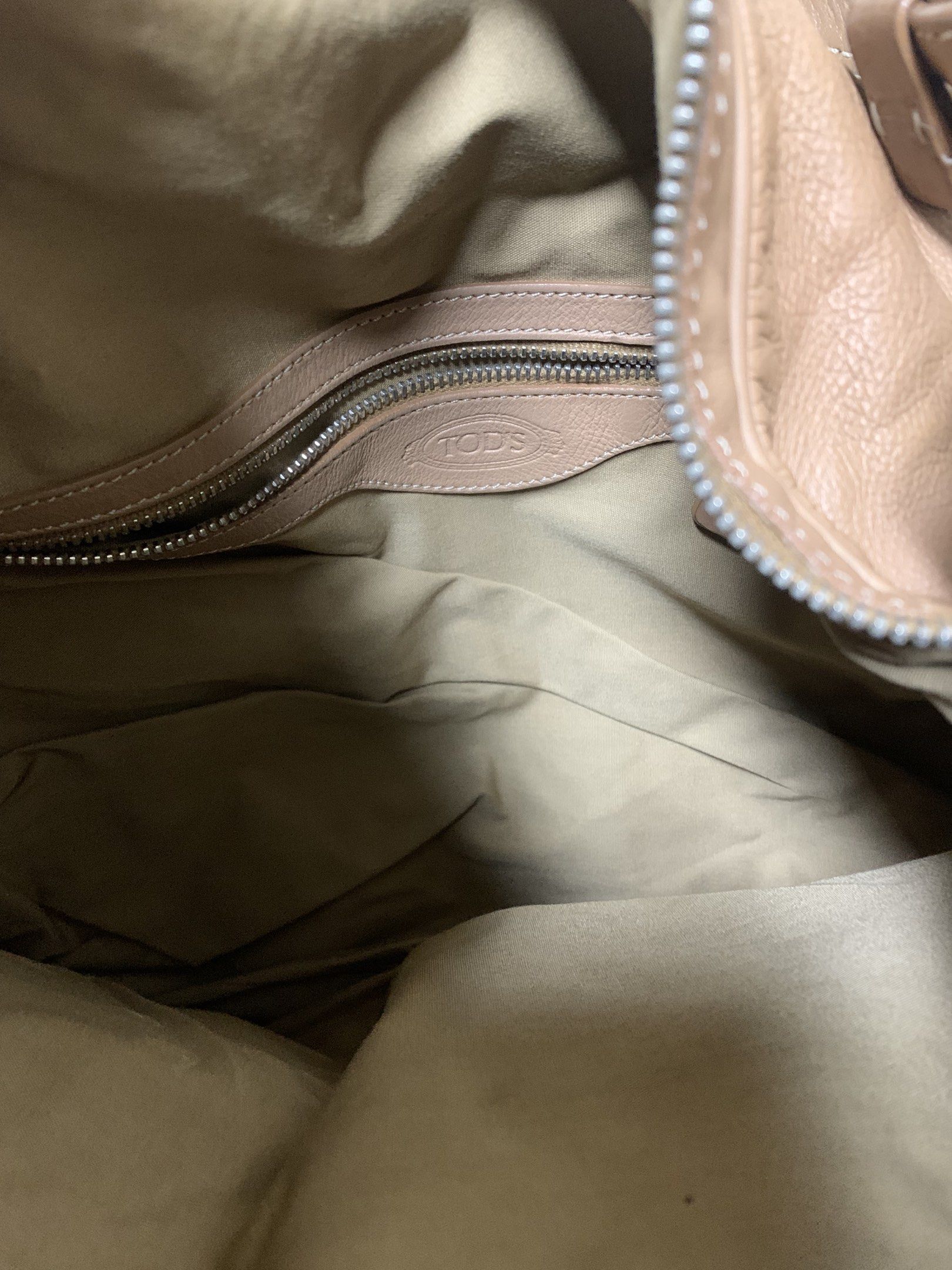Authentic Tod's Leather Bag (Category: Luxury Bags & Wallets) located in San Juan City. Submitted by andyria (Listing ID 1417755921, Image 3). Description: - Tod's shoulder bag - Made of leather - Multiple exterior pockets - Secure zip closure - Versatile top handle and shoulder strap - Iconic Tod's metal clasp Flaw: last pic - faded patch at the back.