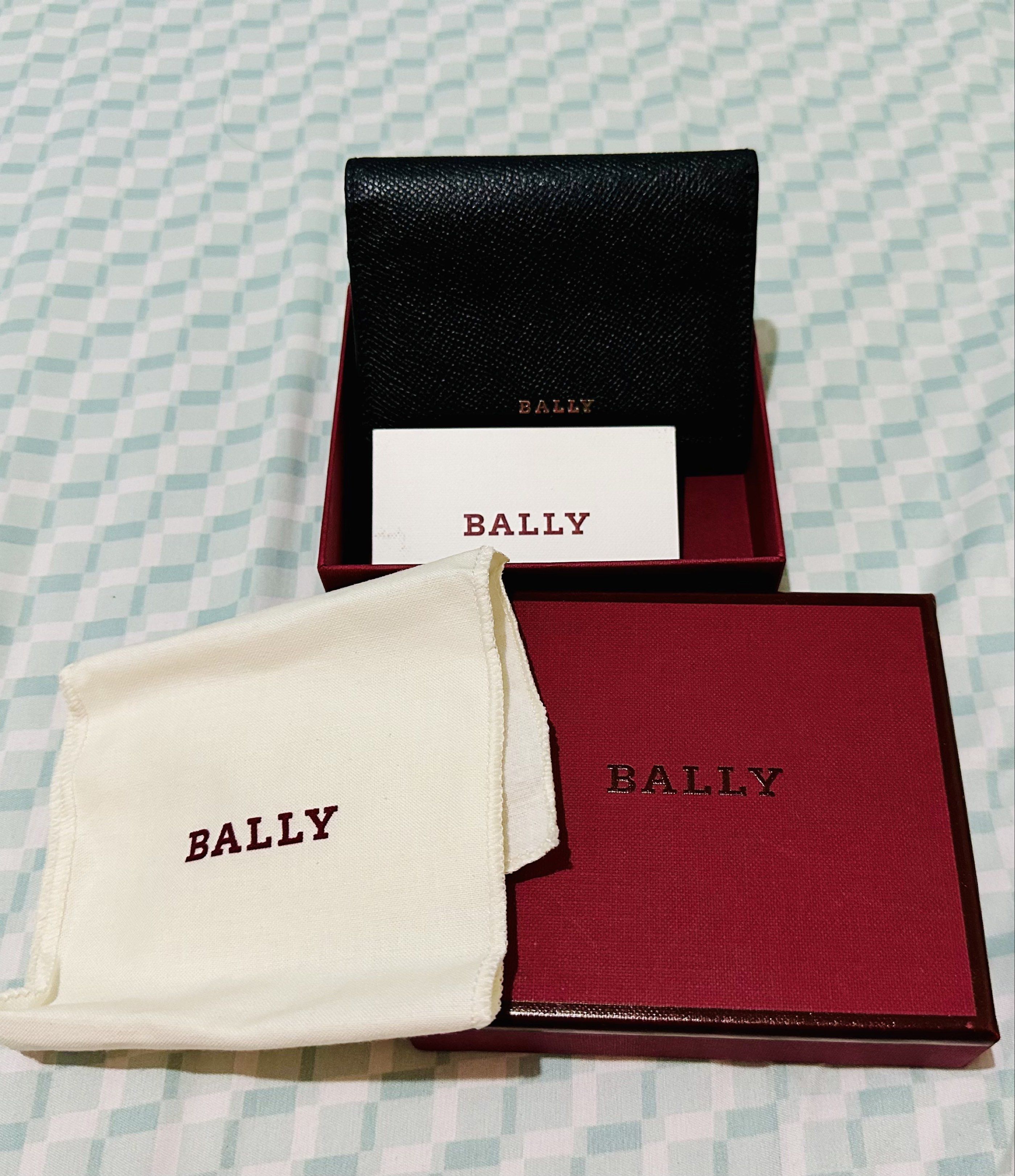 Bally Leather Wallet (Category: Luxury Bags & Wallets) located in Manila. Submitted by ronruiz17 (Listing ID 1419115113, Image 1). Description: - Authentic Bally black leather wallet - Includes original box (deep red color), dust bag (cream-colored), and card - Features the iconic Bally logo.