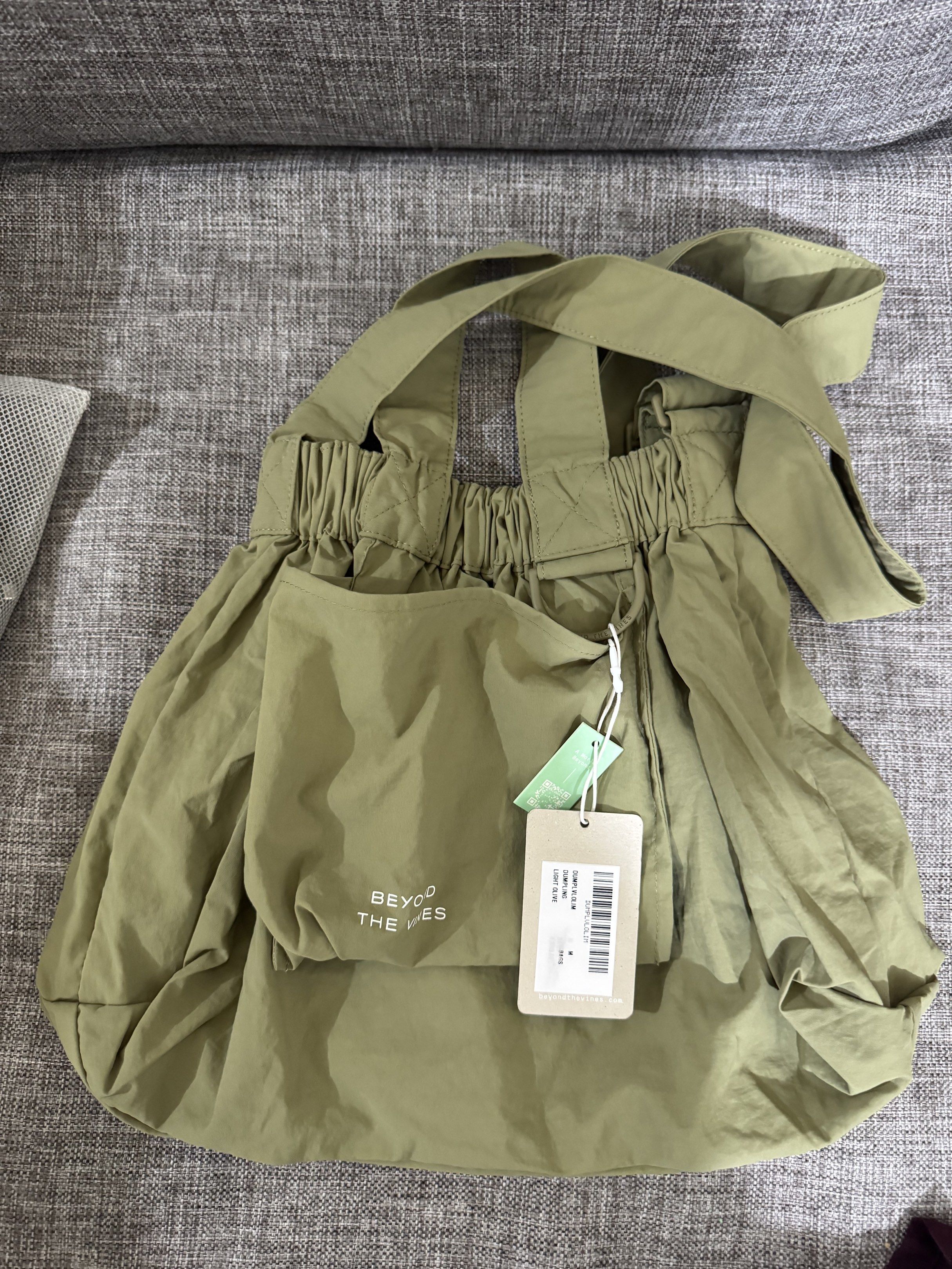 Beyond The Vines Dumpling Bag - Light Olive (M) (Category: Cross-body Bags) located in Mandaluyong City. Submitted by fidgetcracker (Listing ID 1418993497, Image 1). Description: - Beyond The Vines Dumpling Bag - Color: Light Olive - Size: M - Features: Front pocket, gathered design - Includes: Original tags, handles, and shoulder strap - Perfect for everyday use.