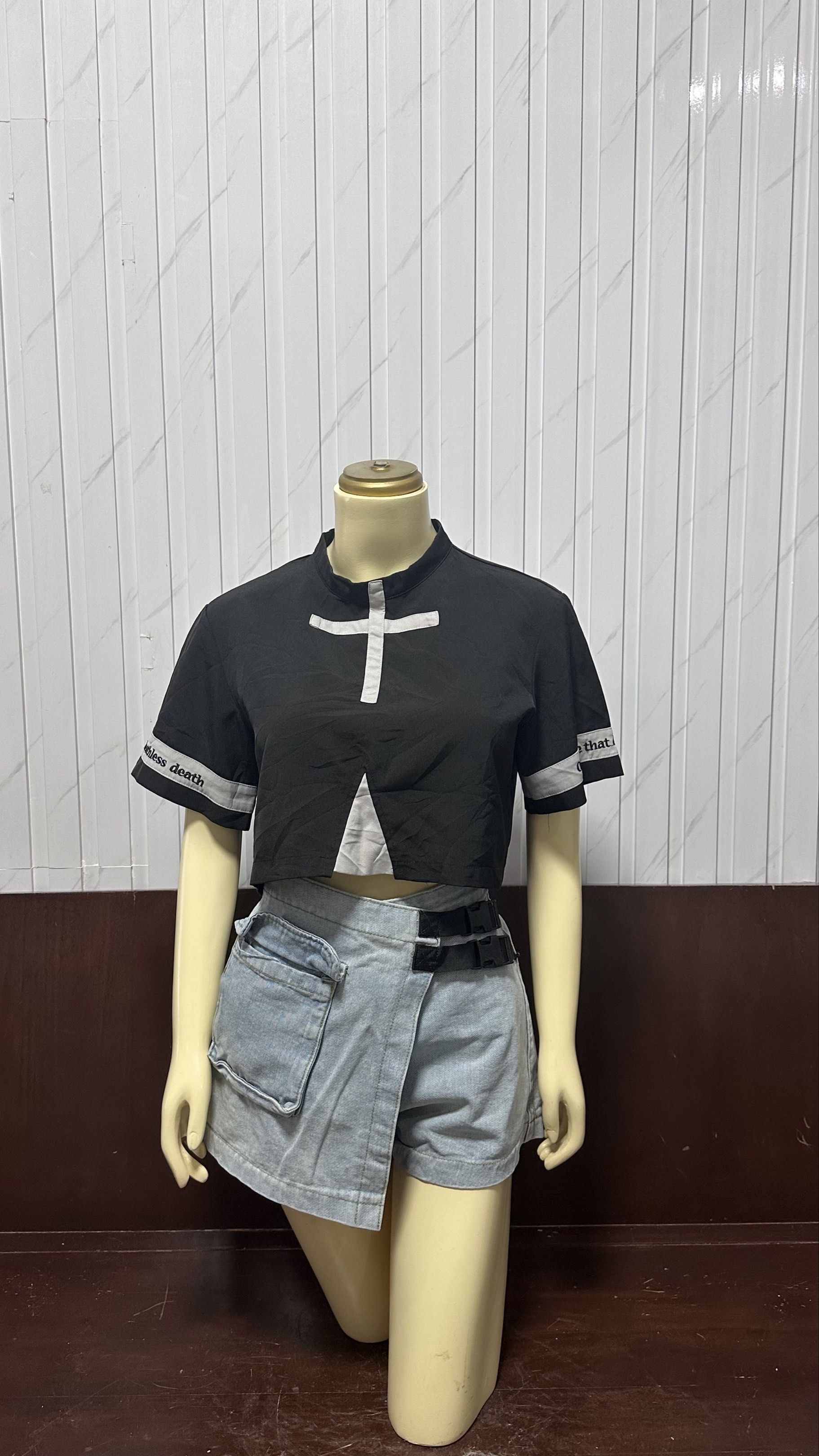 Black Crop Top (Category: Sets or Coordinates) located in Taguig. Submitted by ylluhhhh (Listing ID 1419192209, Image 1). Description: - Black crop top with white cross design and text on sleeves - High collar - Denim shorts with wrap-around design - Light wash - Includes black belt - Fashionable and ready-to-wear.