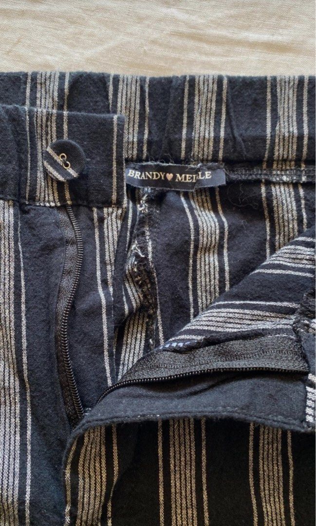 Brandy Melville Tilden Black Striped Pants (Category: Other Bottoms) located in Manila. Submitted by frftch (Listing ID 1419009716, Image 3). Description: - Brand: Brandy Melville - Style: Striped pants - Closure: Button and zipper - Design: Classic striped pattern with slit at the bottom - Elastic waist, stretches a little - 24 width + (brandy size) .