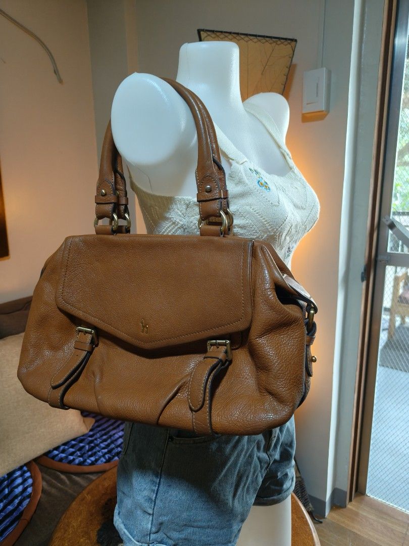 Brown Leather Handbag (Category: Luxury Bags & Wallets) located in Quezon City. Submitted by prelovee19 (Listing ID 1419122029, Image 1). Description: - Brown leather handbag - Top handle design - Flap closure with buckle details - Structured silhouette - Spacious interior - Textured leather finish - Classic and versatile design.