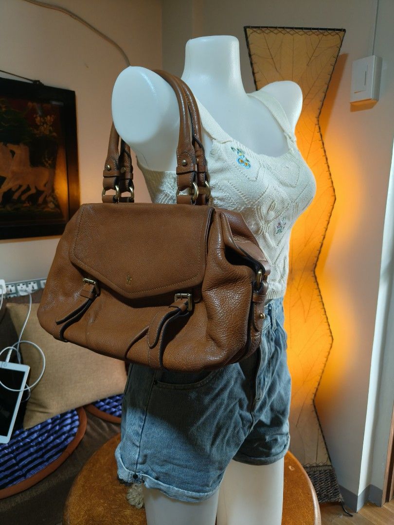 Brown Leather Handbag (Category: Luxury Bags & Wallets) located in Quezon City. Submitted by prelovee19 (Listing ID 1419122029, Image 2). Description: - Brown leather handbag - Top handle design - Flap closure with buckle details - Structured silhouette - Spacious interior - Textured leather finish - Classic and versatile design.