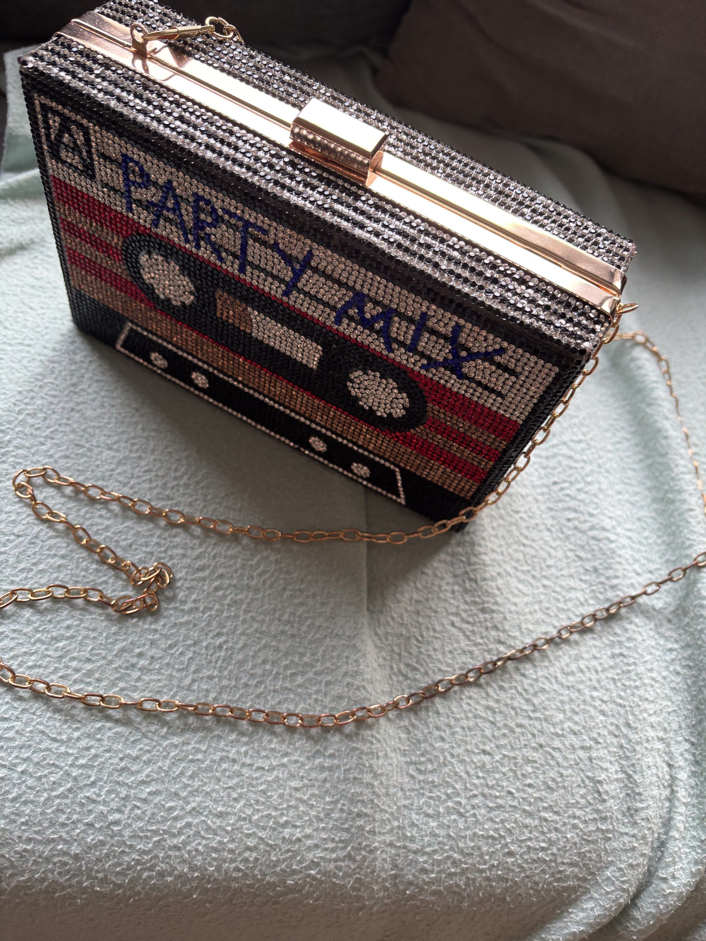 Cassette Tape Clutch Bag with Chain (Category: Clutches) located in Quezon City. Submitted by capflatwhite (Listing ID 1419053447, Image 2). Description: Retro Cassette Tape Clutch ✨ Unique cassette-design clutch with rhinestone details and a gold chain strap. Perfect for parties, nights out, or themed events. ✔️Used only once and still in great condition. 💰Original price: PHP 595.