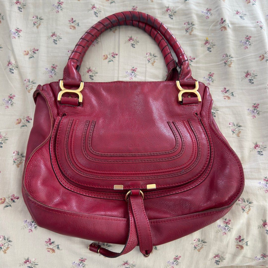 Chloe Marcie Handbag (Category: Luxury Bags & Wallets) located in Makati City. Submitted by tinkerboy (Listing ID 1419133201, Image 1). Description: - Authentic Chloe Marcie handbag - Color: Red - Design: Top handle with flap closure - Hardware: Gold-tone - Condition: Shows wear, particularly on handles - Material: Leather - Features: Structured shape.