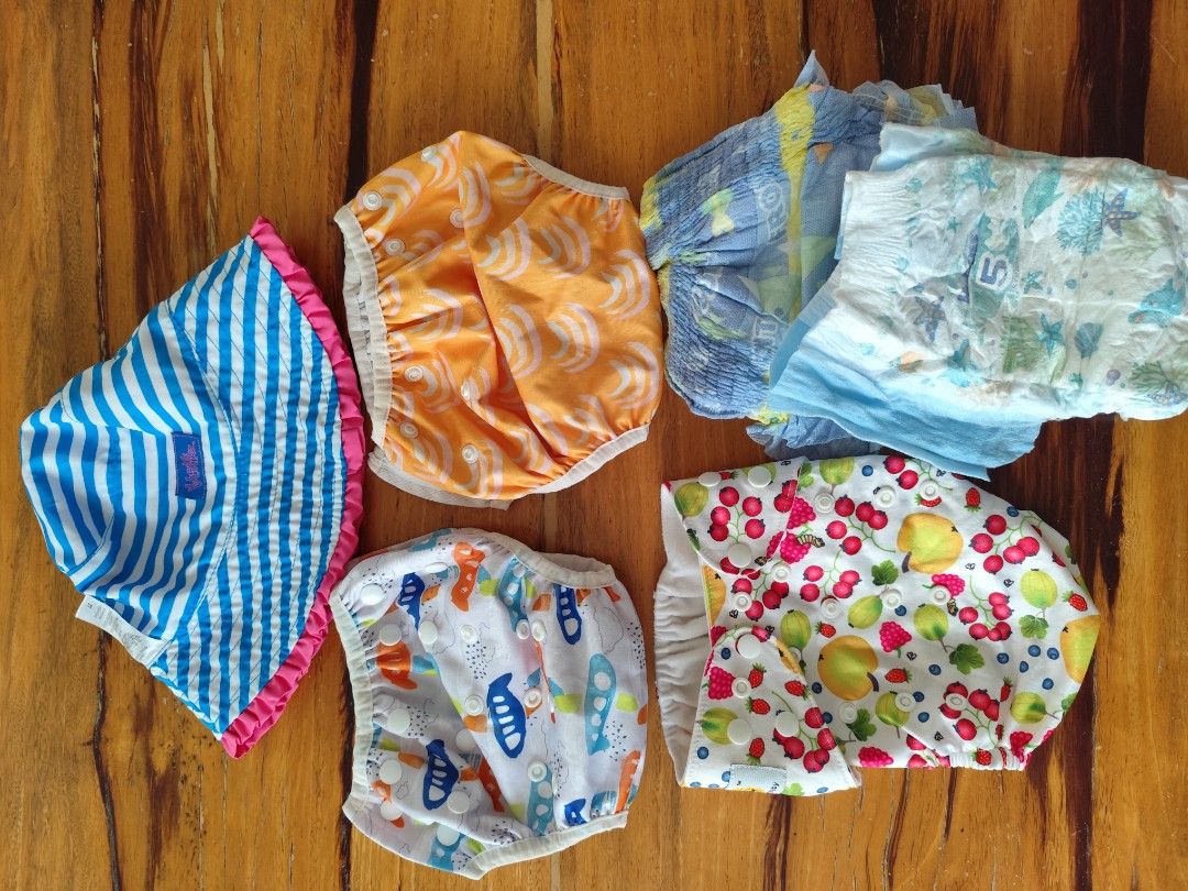 Cloth Diapers and Disposable Swim Diapers (Category: Diapers & Baby Wipes) located in Urdaneta. Submitted by mrspelss (Listing ID 1419063813, Image 1). Description: preloved swim diapers, like new brand new disposable swim diapers sold as lot - Assorted cloth diapers with fun patterns (blue stripes, orange swirls, fish, fruit). - Includes disposable diapers. - Ideal for babies. - Brands and sizes are not specified..