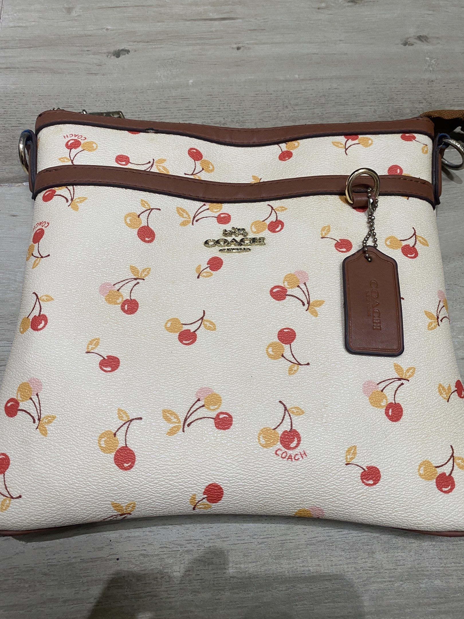 Coach Cherry Print Crossbody Bag (Category: Luxury Bags & Wallets) located in Quezon City. Submitted by itteliashp (Listing ID 1419127204, Image 1). Description: - Coach crossbody bag with cherry print .