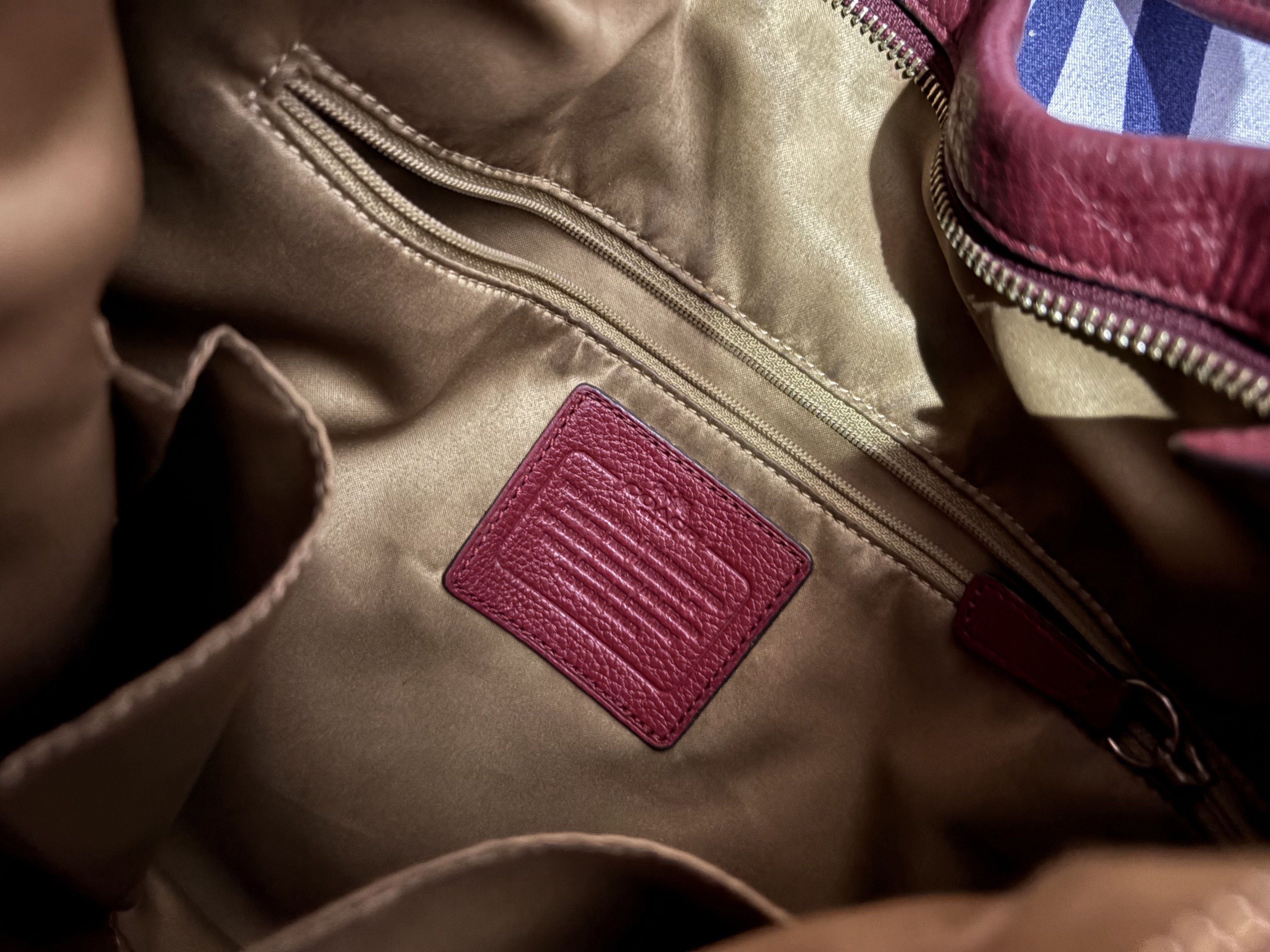 Coach Tote Shoulder Bag (Category: Luxury Bags & Wallets) located in Naga. Submitted by _declutterbym_ (Listing ID 1419158359, Image 3). Description: - burgundy Coach shoulder bag - Spacious interior (kasya ipad, wallet, tumbler) - no issue (so linis for real) - Zip closure - Multiple pockets for organization - Includes Coach hang tag - Pebbled leather texture - Silver Coach logo on the front - Shoulder strap - Side pockets RFS: need funds - nami