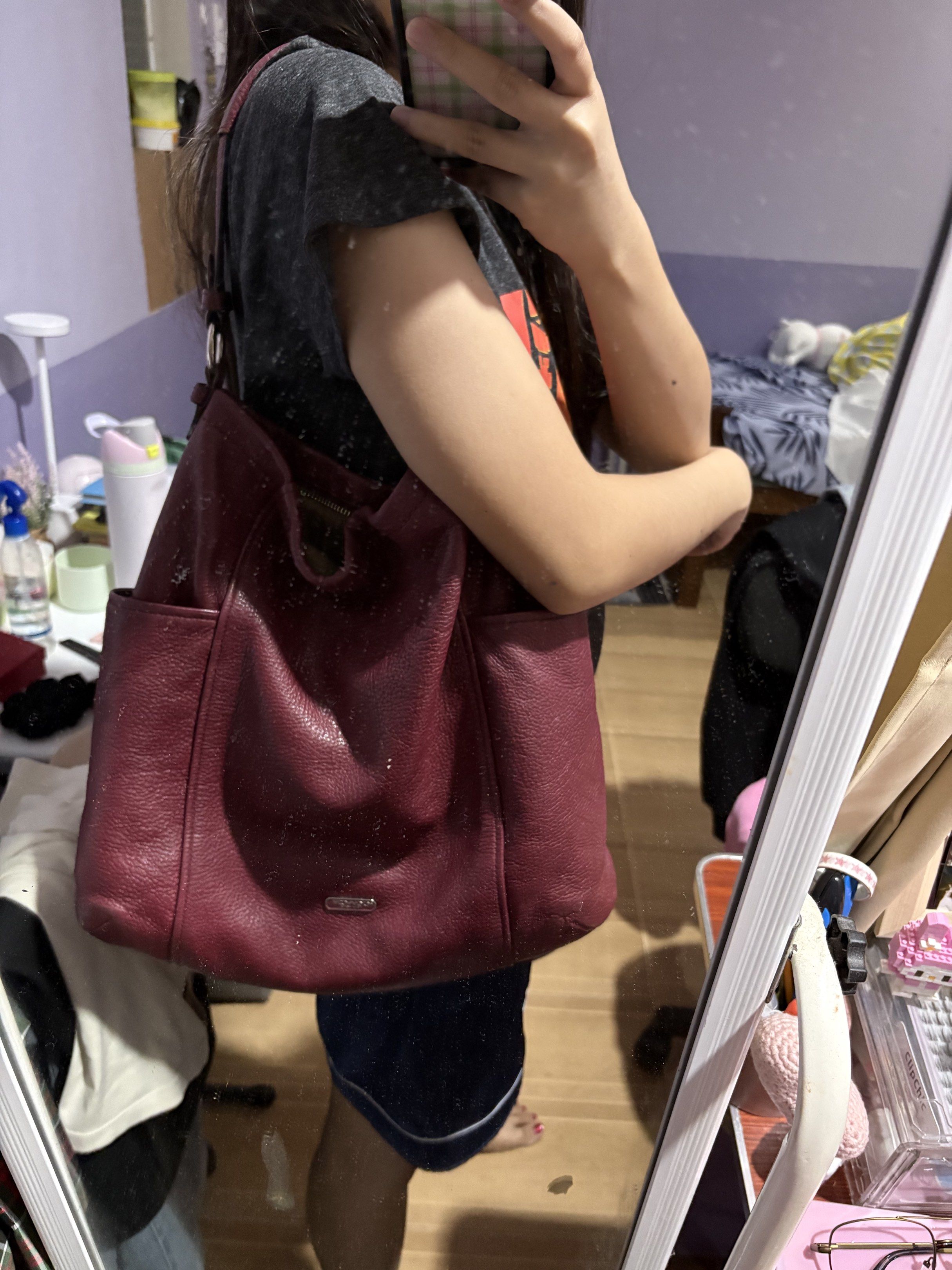 Coach Tote Shoulder Bag (Category: Luxury Bags & Wallets) located in Naga. Submitted by _declutterbym_ (Listing ID 1419158359, Image 2). Description: - burgundy Coach shoulder bag - Spacious interior (kasya ipad, wallet, tumbler) - no issue (so linis for real) - Zip closure - Multiple pockets for organization - Includes Coach hang tag - Pebbled leather texture - Silver Coach logo on the front - Shoulder strap - Side pockets RFS: need funds - nami