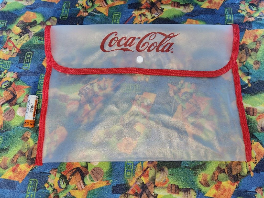 Coca-Cola Pouch (Category: Purses & Pouches) located in Antipolo. Submitted by rllenrapnap (Listing ID 1419001448, Image 1). Description: - Clear Coca-Cola pouch 250 pesos take all 9 pcs - Red trim - Button closure - Durable, transparent material - Features the Coca-Cola logo - Spacious design for various items.