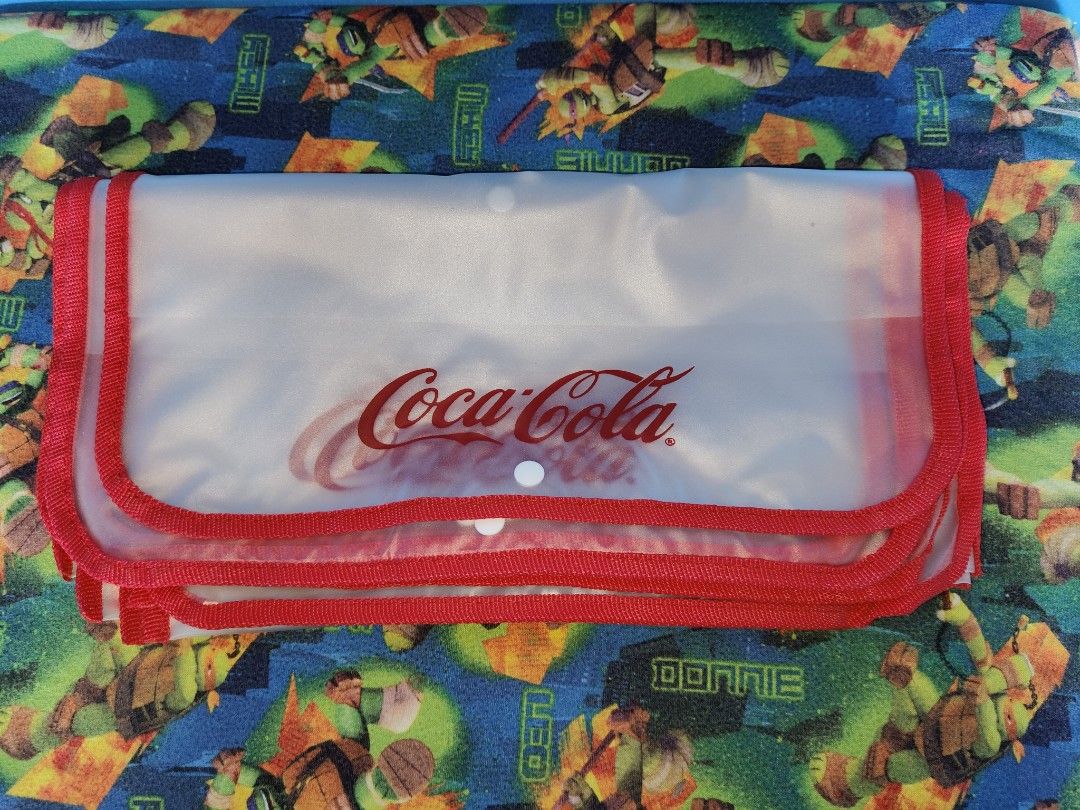 Coca-Cola Pouch (Category: Purses & Pouches) located in Antipolo. Submitted by rllenrapnap (Listing ID 1419001448, Image 2). Description: - Clear Coca-Cola pouch 250 pesos take all 9 pcs - Red trim - Button closure - Durable, transparent material - Features the Coca-Cola logo - Spacious design for various items.