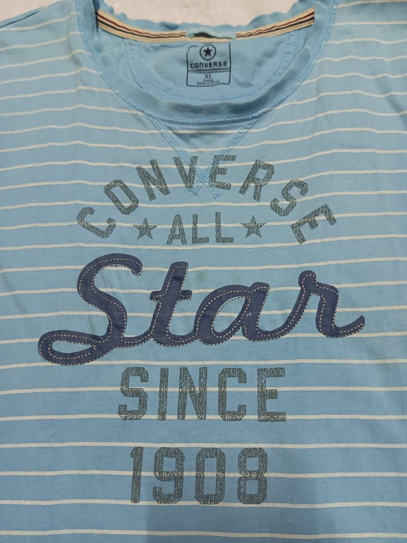 Converse All Star Striped T-shirt (Category: Blouses) located in Malabon City. Submitted by mslalan (Listing ID 1419109346, Image 2). Description: - Converse All Star t-shirt - Light blue and white stripes - Size: XL - Features the Converse All Star logo - Text: "SINCE 1908" - Short sleeves - Round neckline.