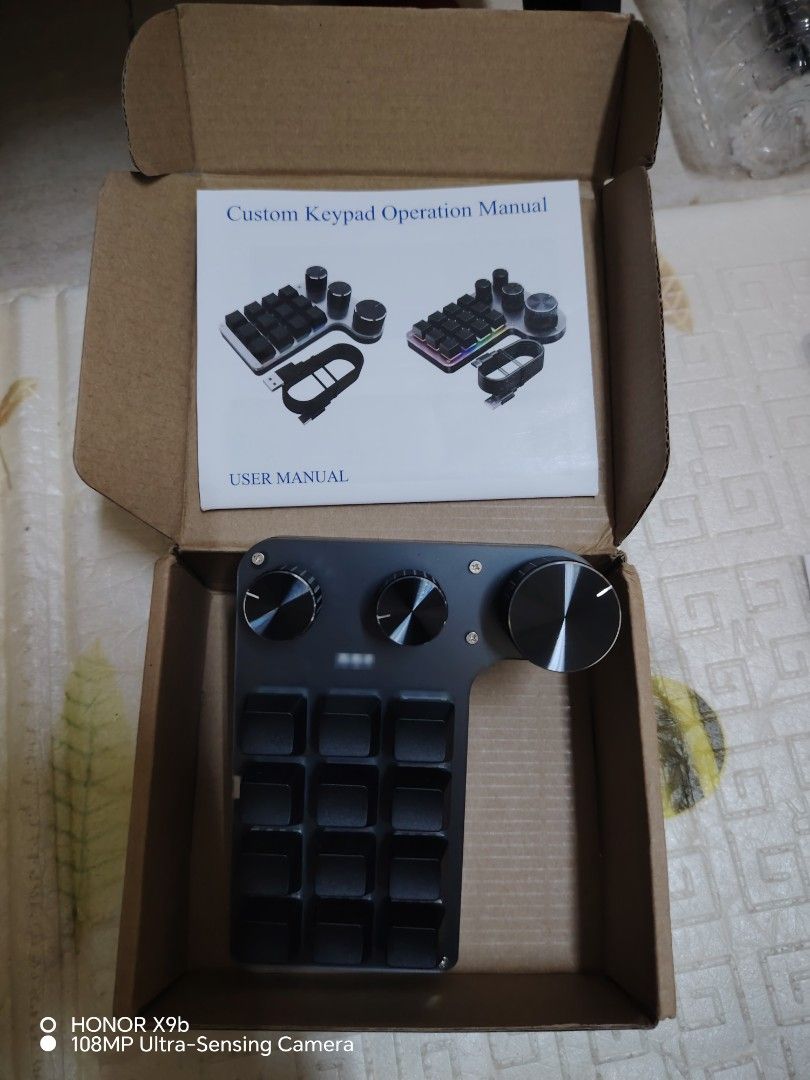 Custom Keypad with Knobs and Buttons (Category: Computer Keyboard) located in Sabak Bernam. Submitted by _wansambal91 (Listing ID 1419131388, Image 1). Description: - Custom keypad with multiple buttons and knobs - Sleek black finish - Features a USB-C port - Buttons arranged in a grid layout - Knobs located at the top - Comes with user manual - Packaged in original box usb cable missing, usb receiver missing tested working correctly using usb ca