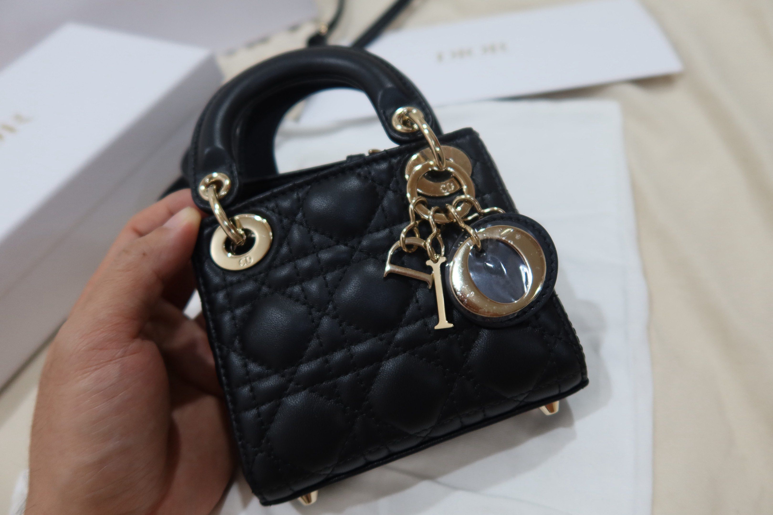 Dior Lady Dior Micro Bag Black (Category: Luxury Bags & Wallets) located in Cabuyao City. Submitted by allorigz (Listing ID 1419126772, Image 2). Description: - Authentic Lady Dior Micro Bag - Black color - Iconic Cannage stitching - Gold-tone hardware - Top handle - Detachable shoulder strap - Includes dust bag and box - Dior charm Complete with receipt Original price 245k.