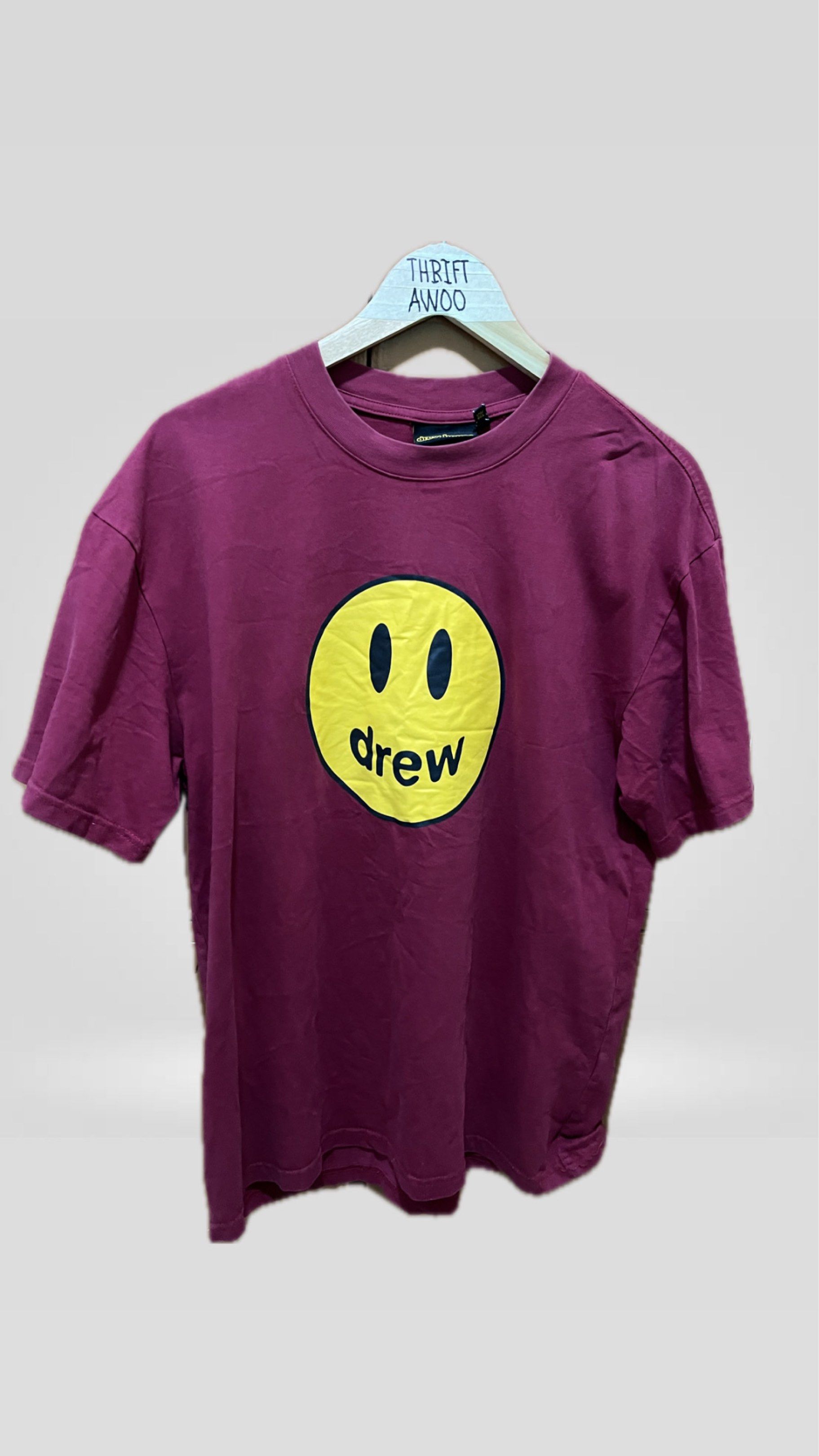 Drew House Smiley Face T-shirt (Category: Tshirts & Polo Shirts ) located in Batangas. Submitted by tregi (Listing ID 1419189753, Image 1). Description: - Drew House T-shirt - Deep maroon color - Features a large yellow smiley face - "drew" brand name printed below - Short sleeves - Crew neck 21/27.