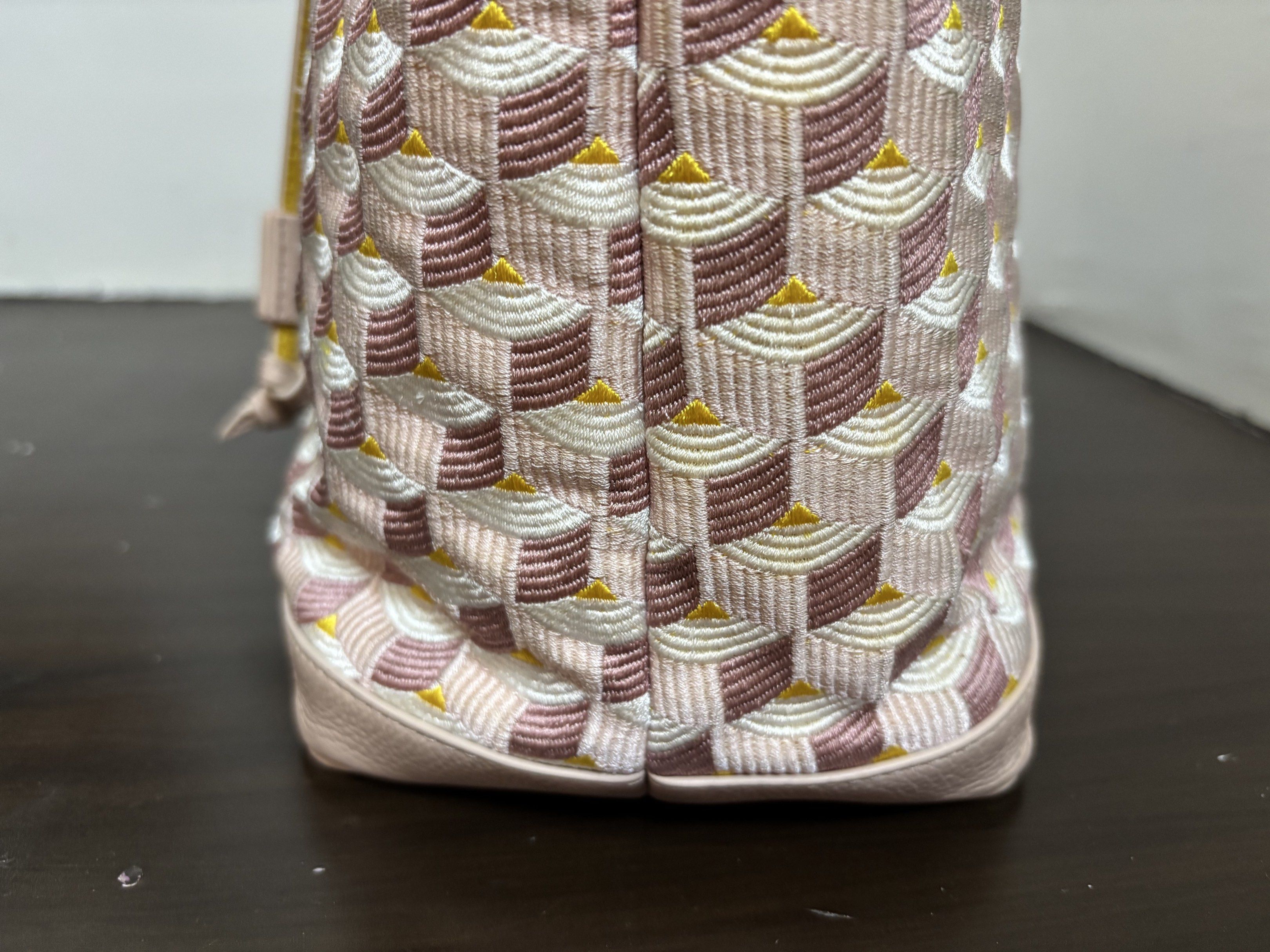 Fauré Le Page Bucket Bag (Category: Luxury Bags & Wallets) located in Lucban. Submitted by cmp341 (Listing ID 1419063756, Image 3). Description: Fauré Le Page bucket bag features a unique geometric pattern in pink and white. It has a drawstring closure and a detachable strap. The bag includes a dust bag and a leather strap with a gold buckle. The bag has gold-tone hardware and the brand's logo is visible. With box, dustbag and care card.