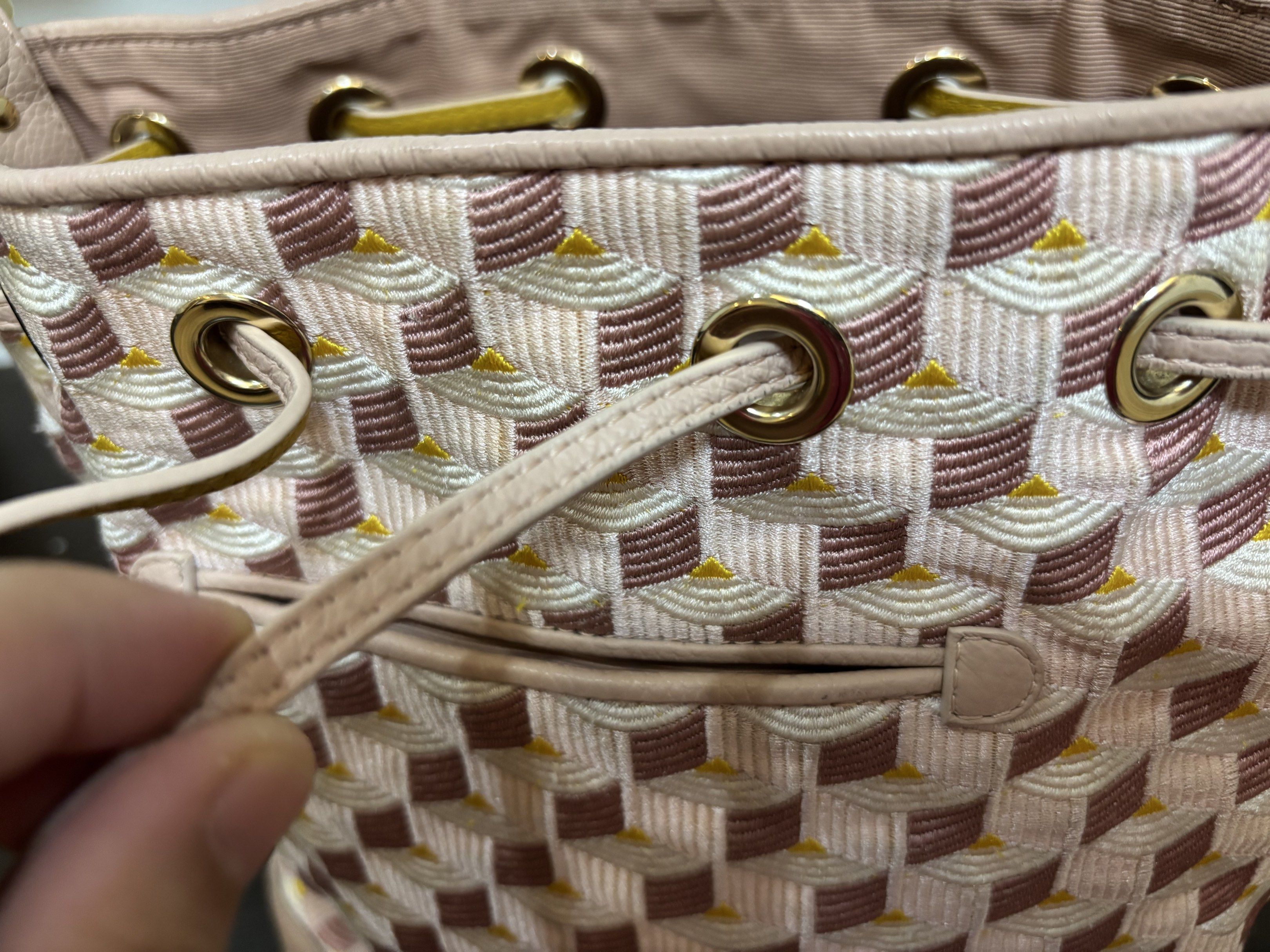 Fauré Le Page Bucket Bag (Category: Luxury Bags & Wallets) located in Lucban. Submitted by cmp341 (Listing ID 1419063756, Image 2). Description: Fauré Le Page bucket bag features a unique geometric pattern in pink and white. It has a drawstring closure and a detachable strap. The bag includes a dust bag and a leather strap with a gold buckle. The bag has gold-tone hardware and the brand's logo is visible. With box, dustbag and care card.