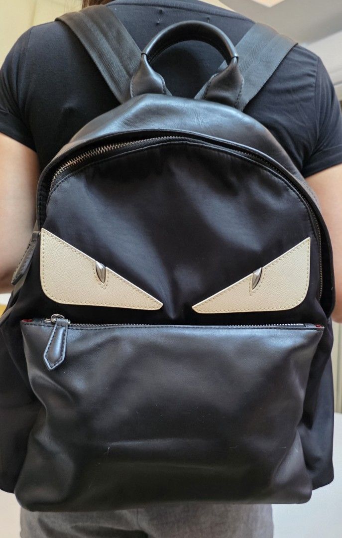 Fendi Eyes Backpack (Category: Luxury Bags & Wallets) located in Caloocan City. Submitted by mangoaddict18 (Listing ID 1419161057, Image 3). Description: - Black backpack with a unique eyes design. - Front zippered pocket for easy access. - Top handle for convenient carrying. - Interior zippered pocket for secure storage. - Adjustable straps for a comfortable fit. - Made from durable leather and nylon materials..