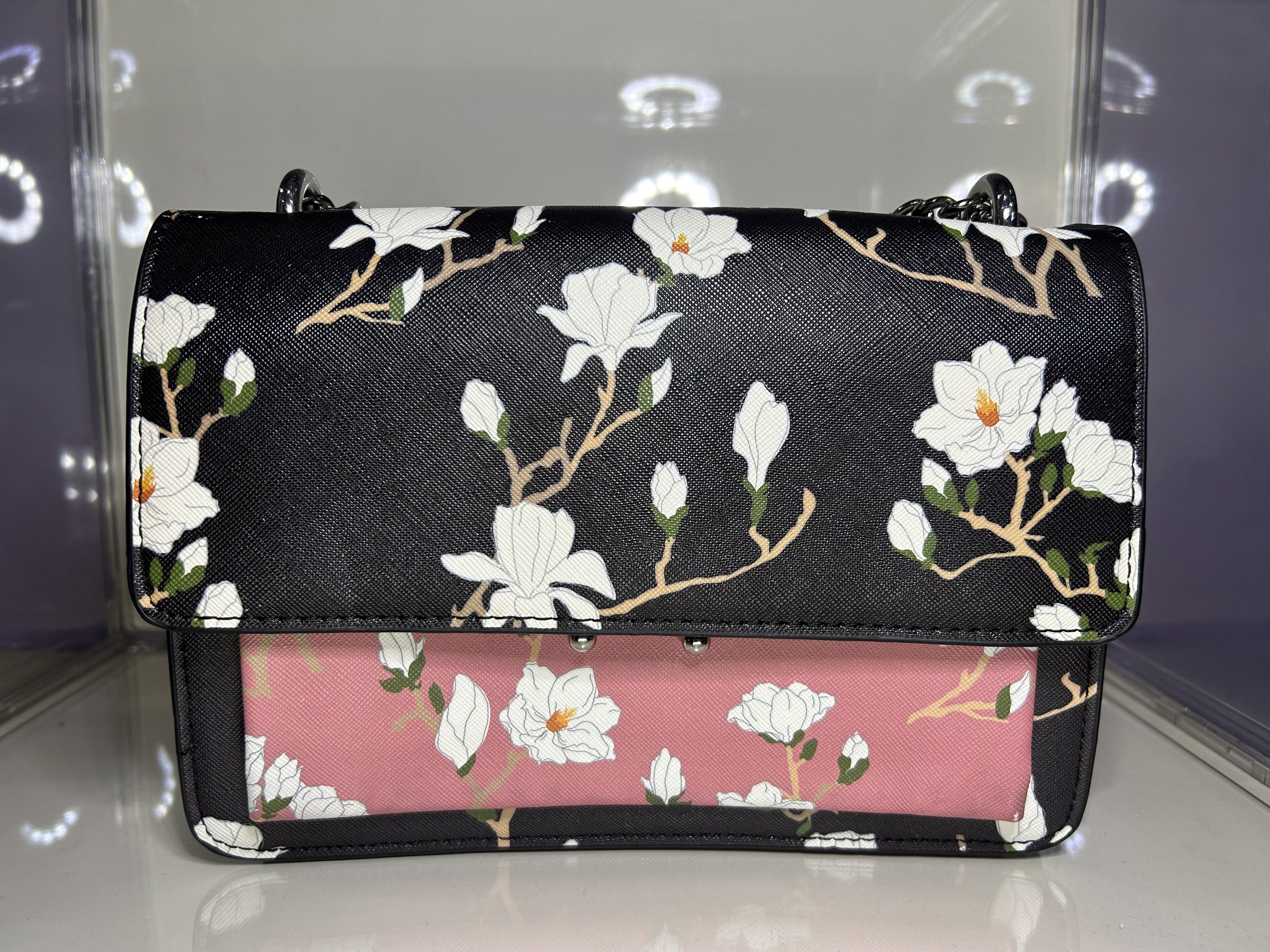 MANGO Chain Bag (Category: Luxury Bags & Wallets) located in Manila. Submitted by vaststar-be11 (Listing ID 1419113187, Image 1). Description: Full Model Name: MANGO Black & Pink Floral Print Sling - Floral print design - Chain strap - Magnetic closure - Black top, pink bottom - Black interior with small pocket - Perfect accessory.