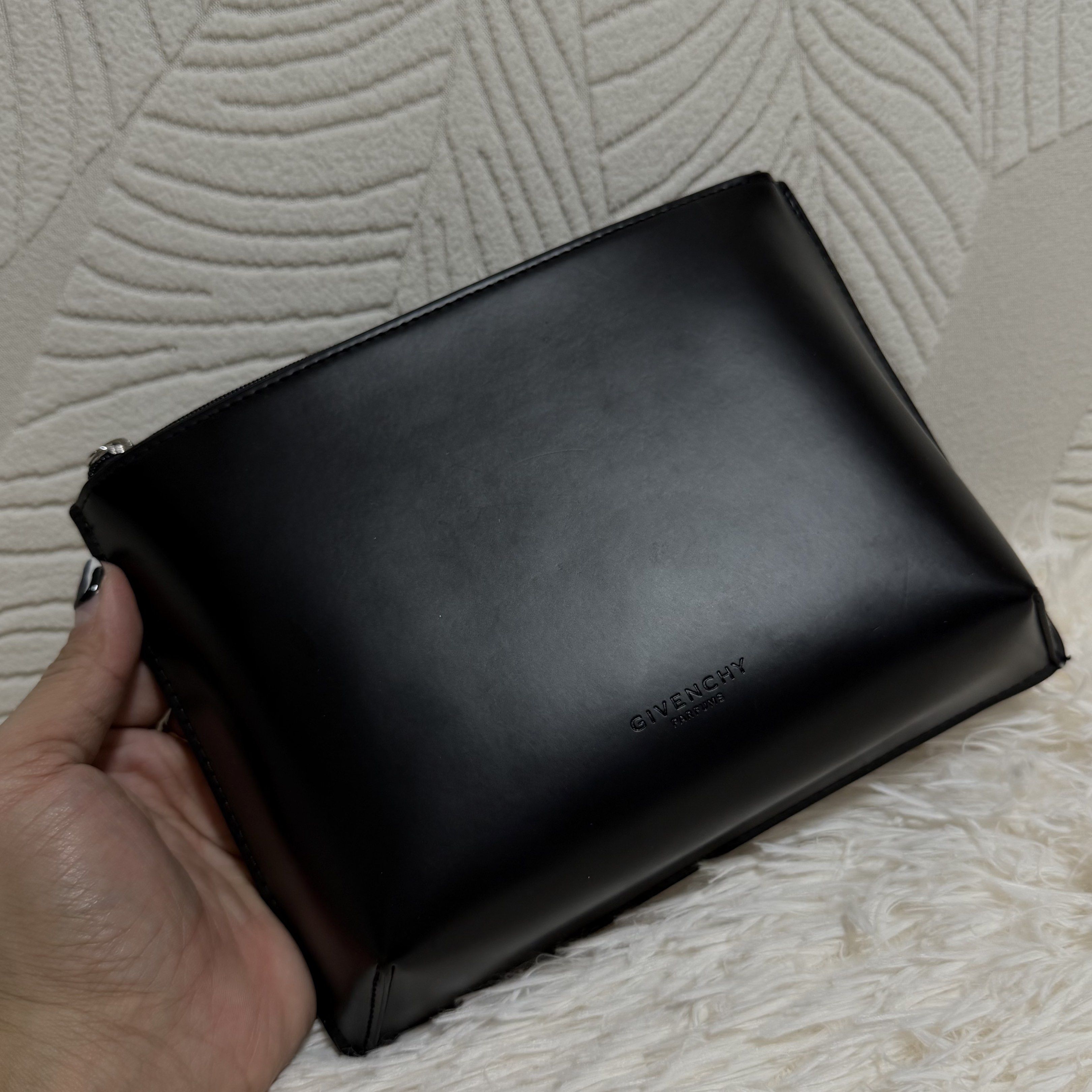 Givenchy Novelty pouch (Category: Luxury Bags & Wallets) located in Pasig City. Submitted by trendapparelph (Listing ID 1418992637, Image 2). Description: - Givenchy Novelty Pouch - Classic black color - Features the Givenchy logo - Stylish and versatile design - Interior lining with a unique pattern.