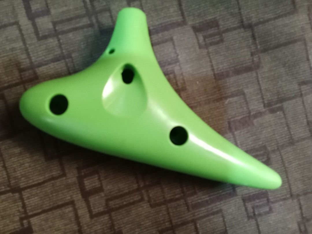 Green Ocarina (Category: Musical Instruments) located in Bocaue. Submitted by marajapansurplus (Listing ID 1418996983, Image 2). Description: - Green ocarina - Features multiple holes and a mouthpiece - Marked with "AC" - Musical instrument - Easy to play.