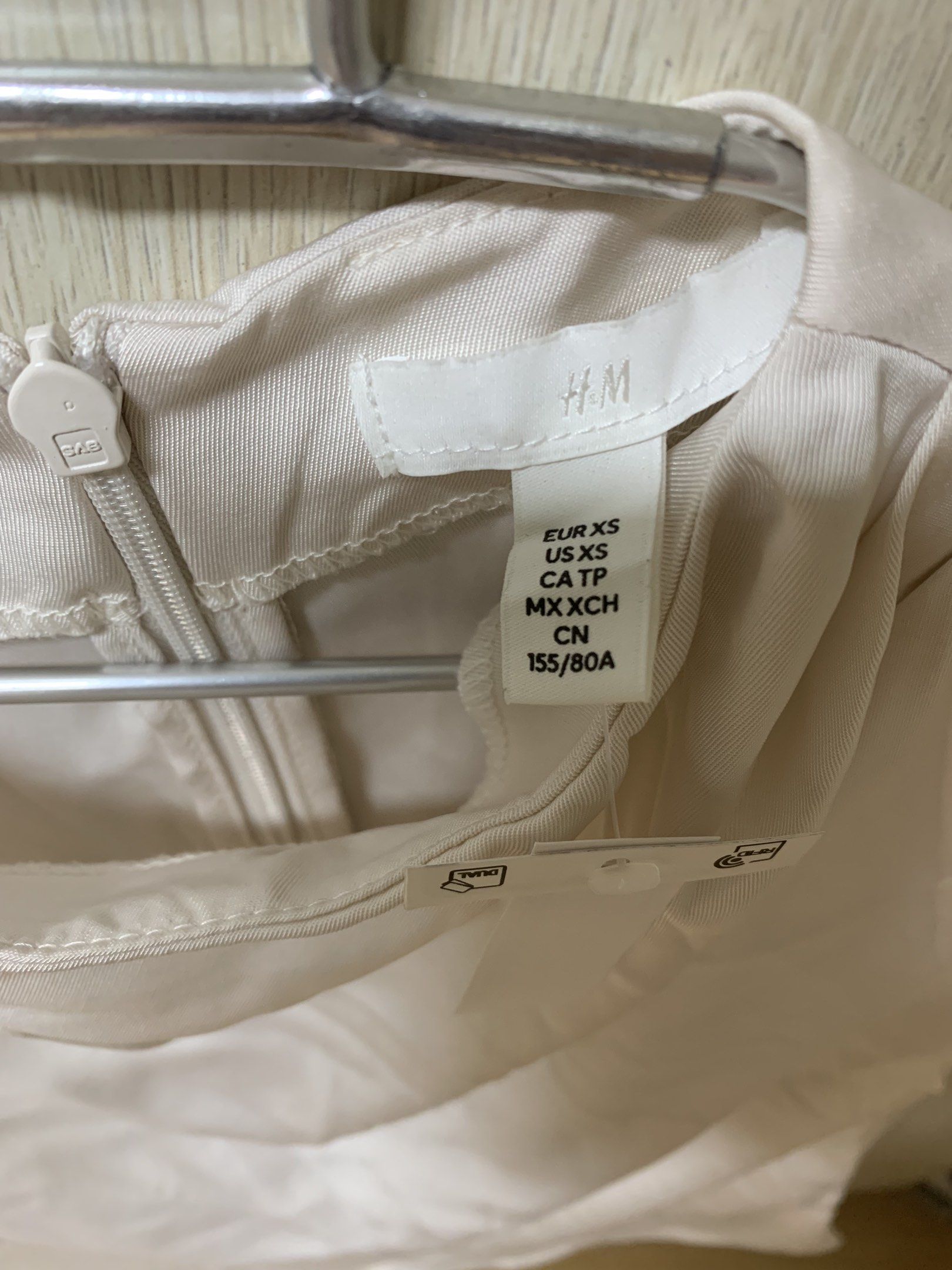 H&M Silky White blouse top (Category: Sleeveless) located in San Juan City. Submitted by andyria (Listing ID 1419137433, Image 2). Description: - H&M white top - Size: XS - Features: Round neckline, cap sleeves, draped front - Style: Minimalist, elegant - Fabric: lightweight and smooth - Occasion: Casual or semi-formal.