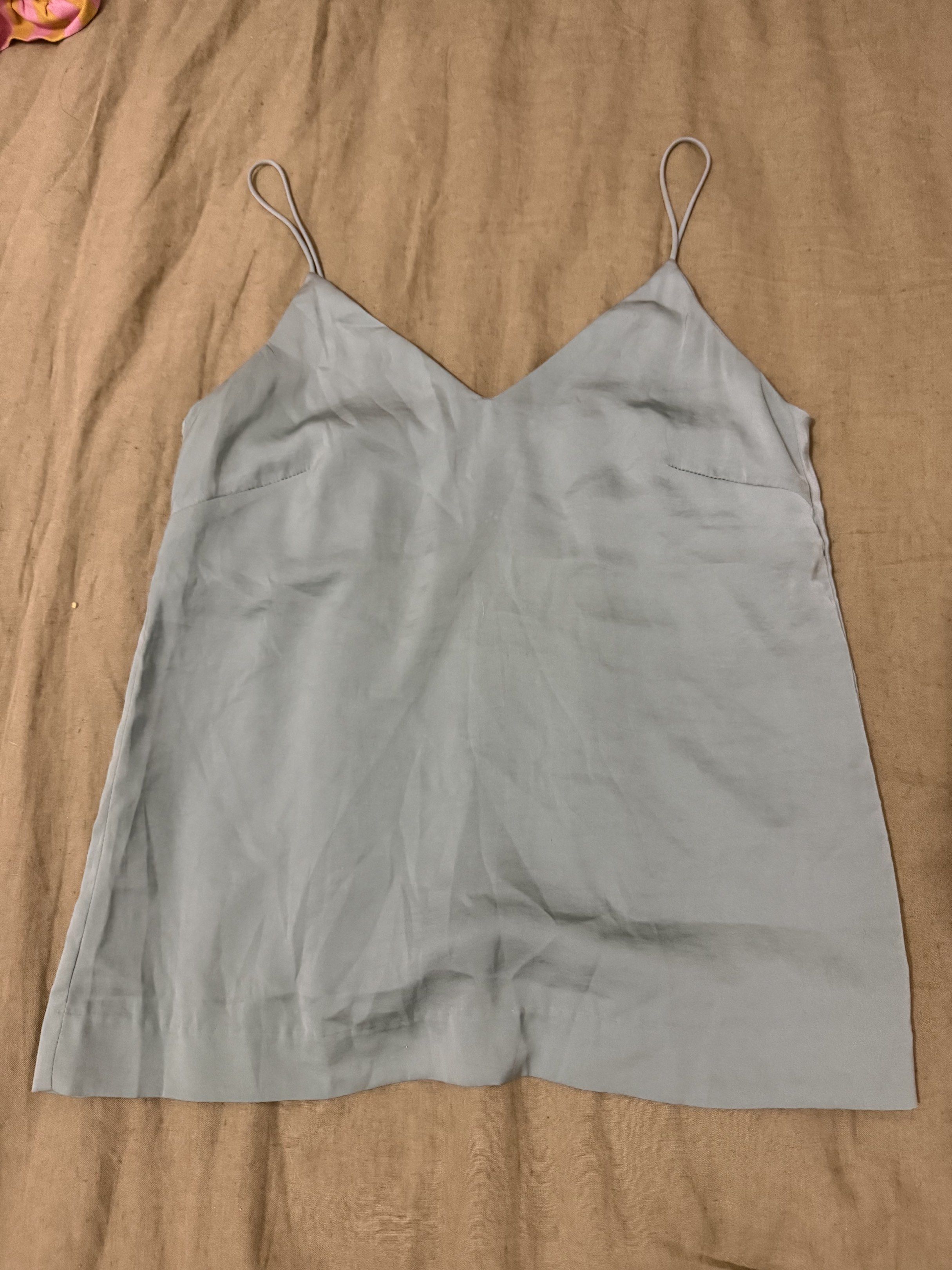 H&M V-neck Cami Top (Category: Sleeveless) located in Paranaque City. Submitted by bailey_cade (Listing ID 1419143559, Image 1). Description: - H&M cami top - Light blue color - V-neck design - Spaghetti straps - Size: EUR 36, US 6, CA 6, CN 165/84A - Measurements: Approximately 16 inches across the chest, 24 inches in length.