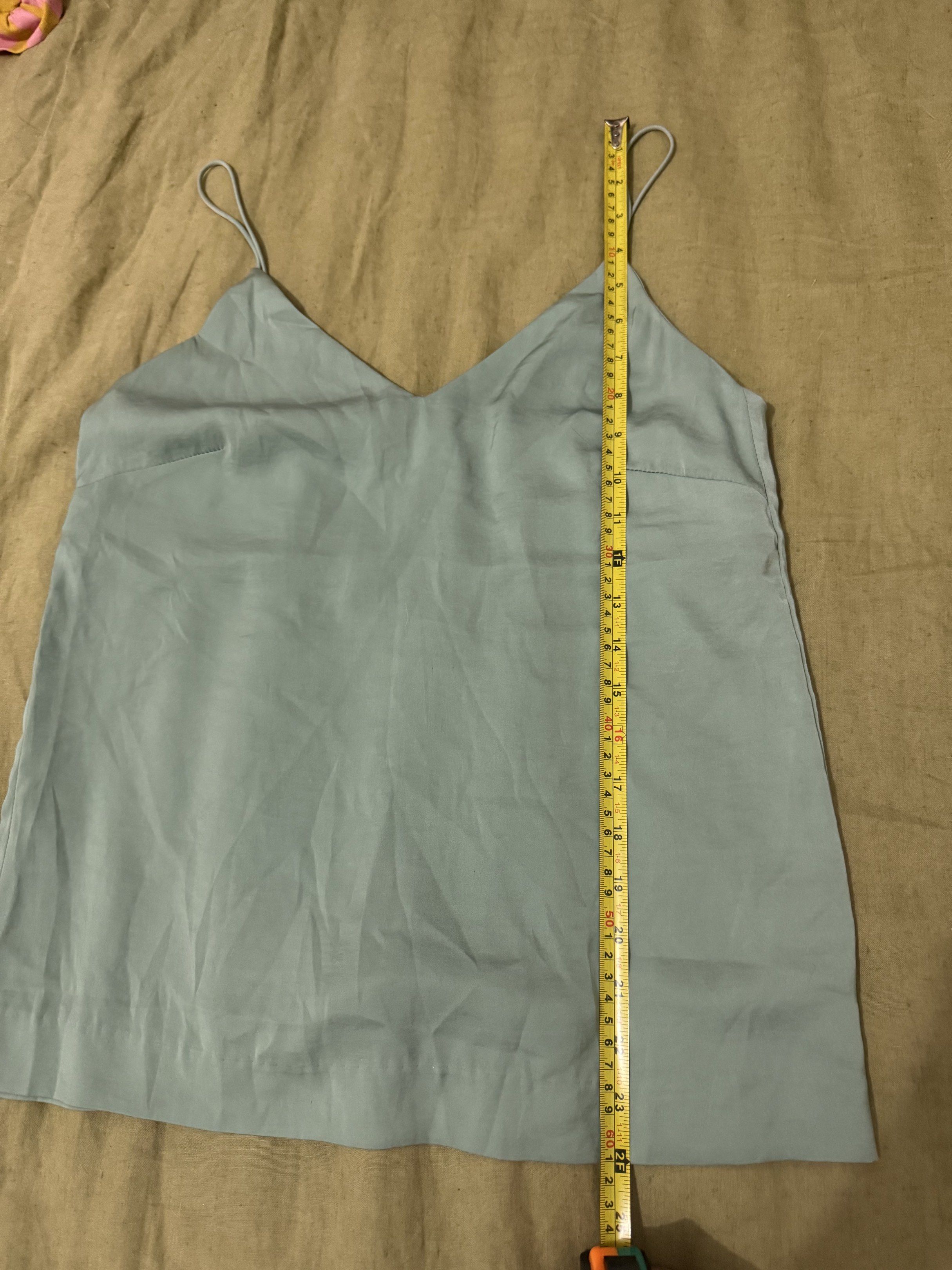 H&M V-neck Cami Top (Category: Sleeveless) located in Paranaque City. Submitted by bailey_cade (Listing ID 1419143559, Image 3). Description: - H&M cami top - Light blue color - V-neck design - Spaghetti straps - Size: EUR 36, US 6, CA 6, CN 165/84A - Measurements: Approximately 16 inches across the chest, 24 inches in length.