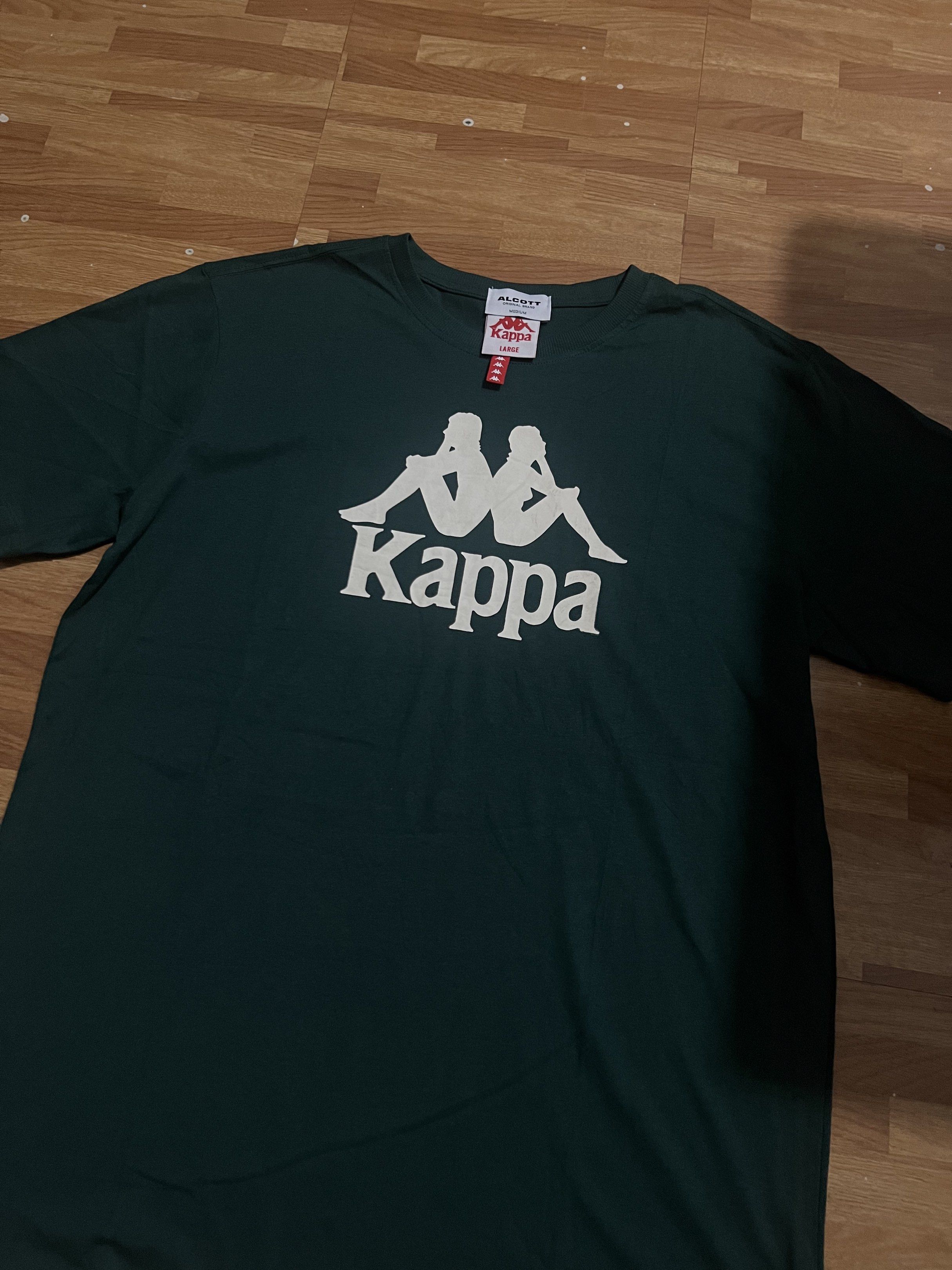 Kappa T-shirt (Category: Tshirts & Polo Shirts ) located in Makati City. Submitted by msverify (Listing ID 1419118873, Image 1). Description: - Dark green Kappa T-shirt - White Kappa logo on the front - Crew neck and short sleeves - Brand: Alcott - Available sizes: Large, Medium.