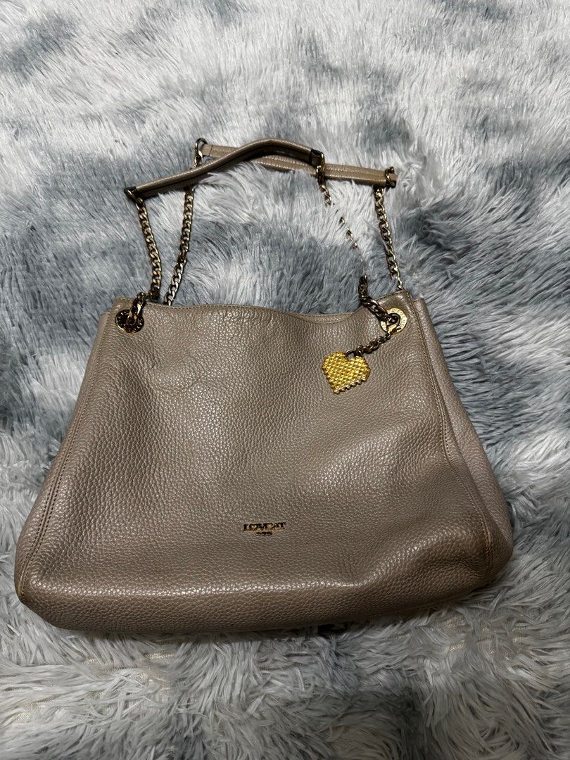 Lovcat Shoulder Bag Sling Bag with Chain Gray (Category: Shoulder Bags) located in Cavite. Submitted by em929 (Listing ID 1419107723, Image 1). Description: - Chain strap - Heart-shaped charm - Brown interior lining with heart patterns - Multiple compartments - Magnetic closure - Zipper pocket - Neutral color - Textured finish.