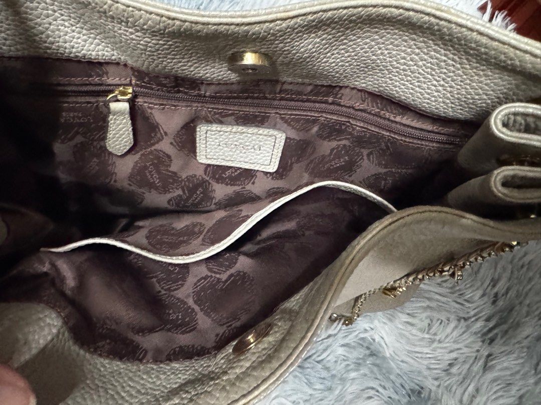 Lovcat Shoulder Bag Sling Bag with Chain Gray (Category: Shoulder Bags) located in Cavite. Submitted by em929 (Listing ID 1419107723, Image 3). Description: - Chain strap - Heart-shaped charm - Brown interior lining with heart patterns - Multiple compartments - Magnetic closure - Zipper pocket - Neutral color - Textured finish.