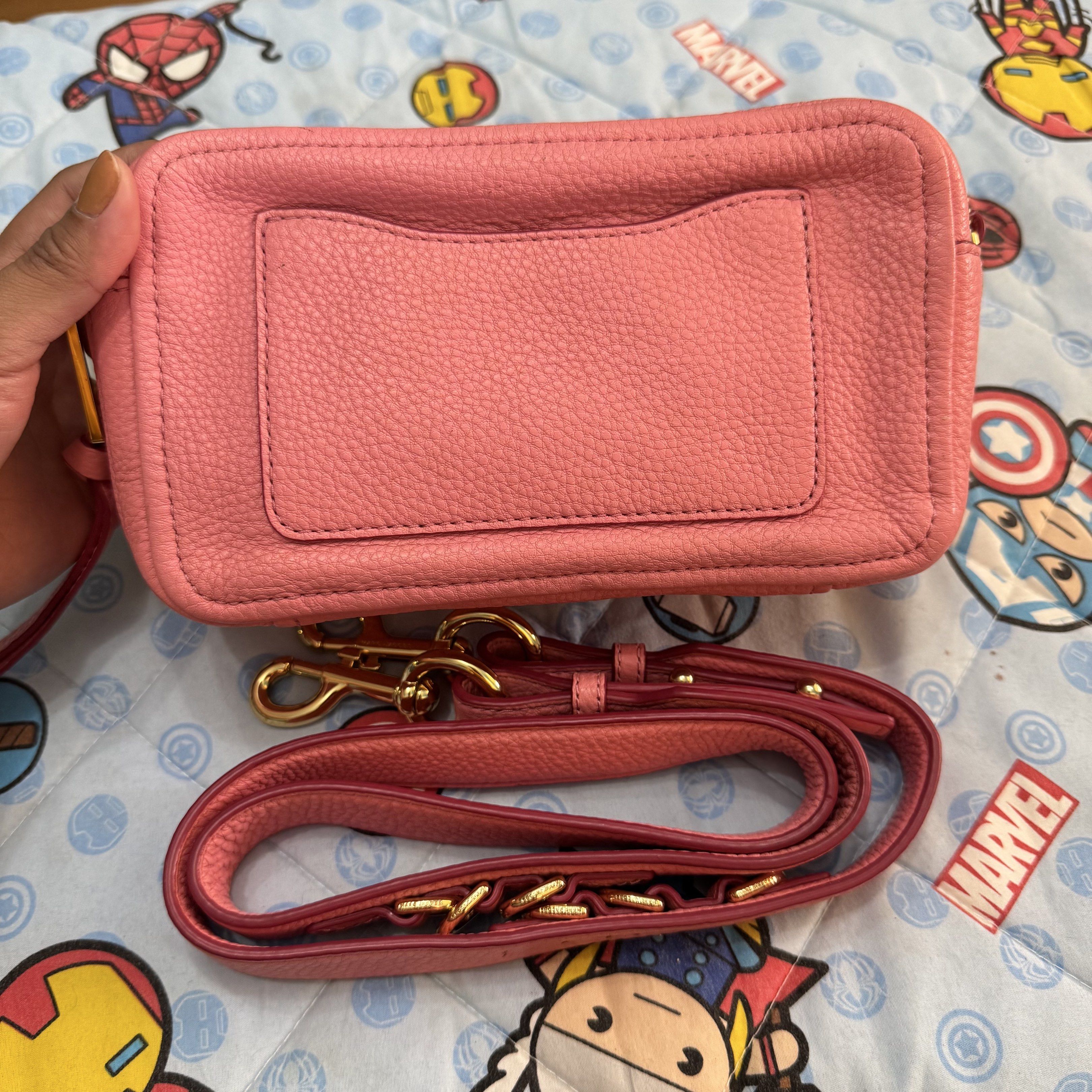 Marc Jacobs The Snapshot Crossbody Bag (Category: Luxury Bags & Wallets) located in Cabugao. Submitted by ydelle (Listing ID 1419001279, Image 2). Description: - Marc Jacobs Snapshot crossbody bag - Pink leather exterior - Gold-tone logo and hardware - Detachable and adjustable strap - Main compartment with card slot - Back pocket - Gold-toned zipper closure - Made in Vietnam.