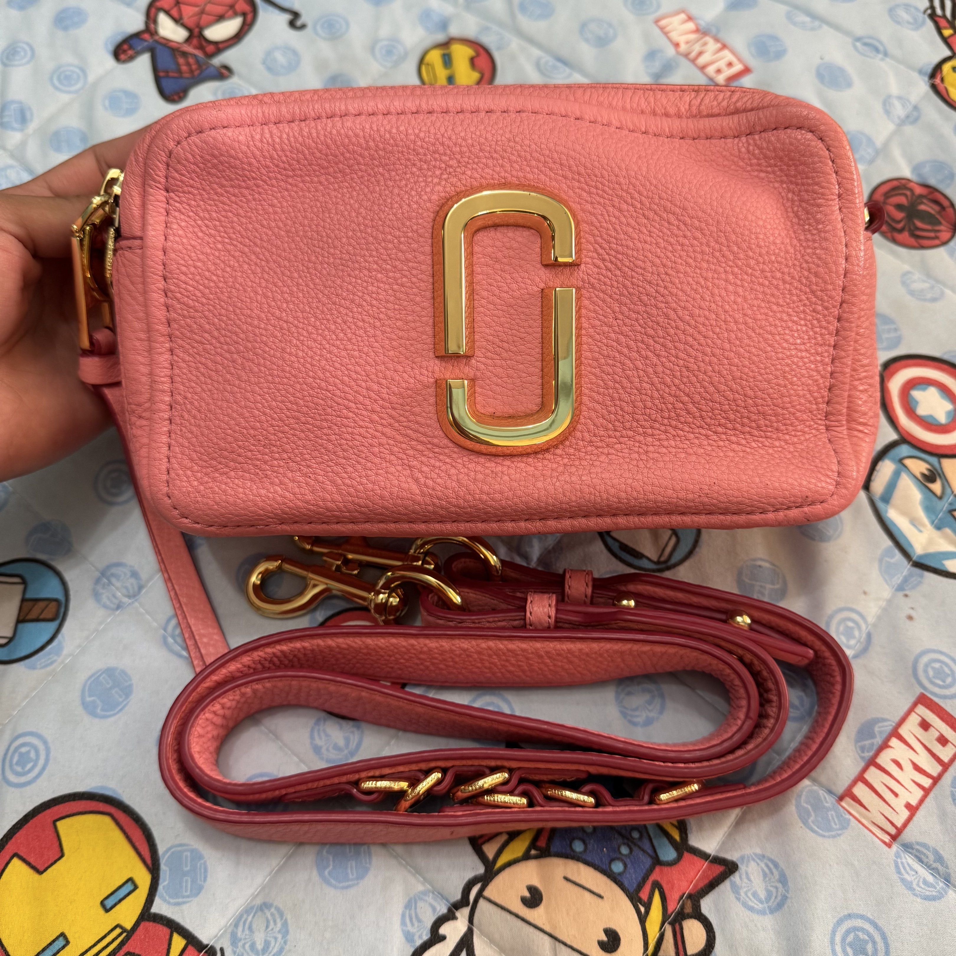 Marc Jacobs The Snapshot Crossbody Bag (Category: Luxury Bags & Wallets) located in Cabugao. Submitted by ydelle (Listing ID 1419001279, Image 1). Description: - Marc Jacobs Snapshot crossbody bag - Pink leather exterior - Gold-tone logo and hardware - Detachable and adjustable strap - Main compartment with card slot - Back pocket - Gold-toned zipper closure - Made in Vietnam.