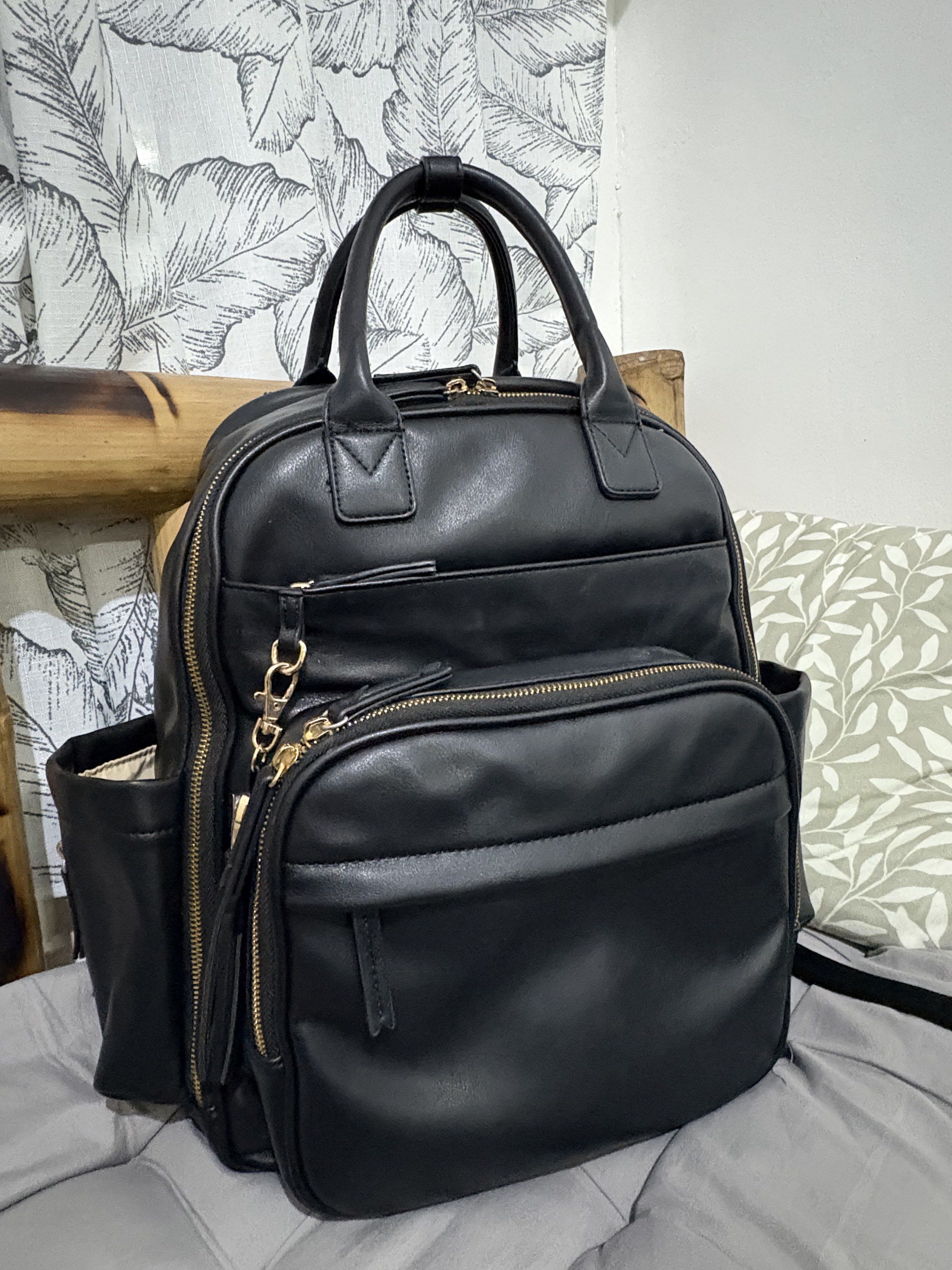 Omanmoli Black Faux Leather Diaper Backpack (Category: Diaper Bags & Wetbags) located in Mandaluyong City. Submitted by mommy_pril (Listing ID 1419100133, Image 1). Description: 🌷Omanmoli diaper backpack in excellent condition !! 🌷Changing pad is included 🌷Adjustable padded shoulder straps and stroller straps, with back pocket if you want to secure the bag on your luggage 🌷Makes 16 pockets in total, with 6 insulated pockets for baby bottles �