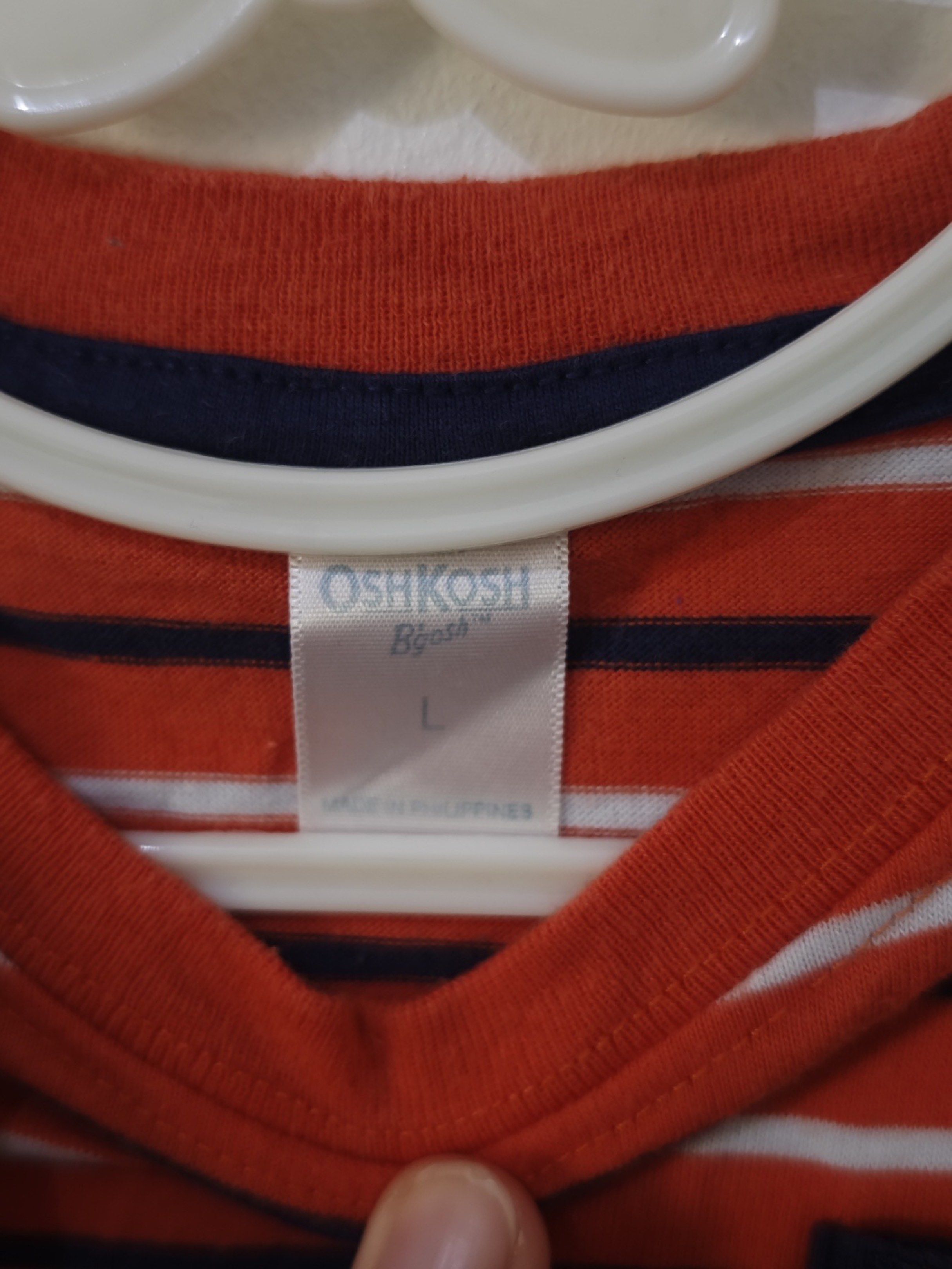 OshKosh B'gosh Striped T-shirt (Category: Babies & Kids Fashion) located in Paranaque City. Submitted by serendipity1021 (Listing ID 1418986358, Image 2). Description: - OshKosh B'gosh t-shirt - Size: L - Features red and white stripes - Navy blue chest pocket - Short sleeves and round neckline - Made in the Philippines.