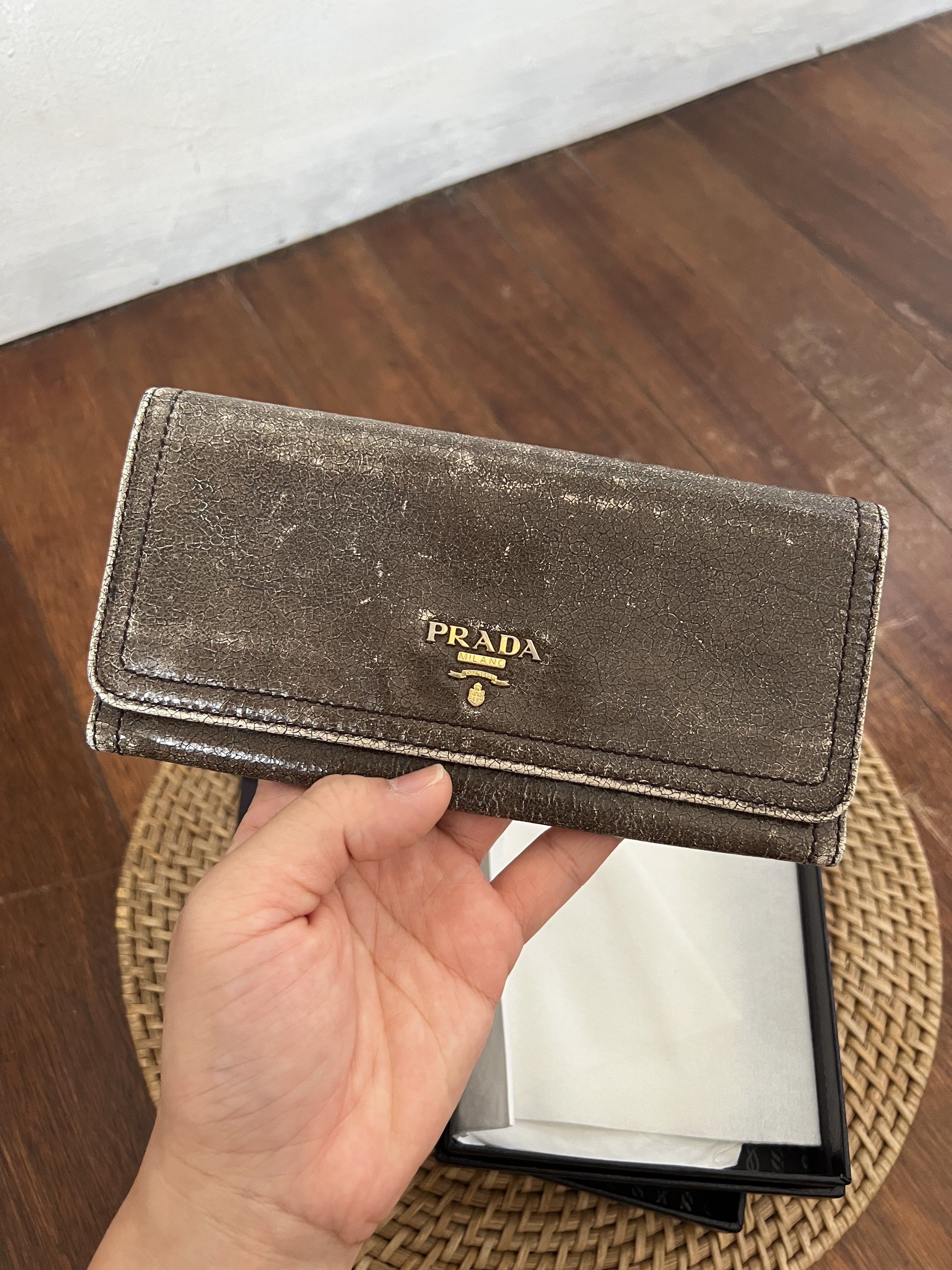 Prada Craquele Long Wallet (Category: Wallets & Card holders) located in Quezon City. Submitted by kdiv_ (Listing ID 1419093818, Image 2). Description: Personal preloved |Guaranteed Authentic Bought in Singapore Inclusions: Authenticity Card and Box Flaw: Faded leather and hardware that gave an overall vintage look RFS: Decluttering, no longer being used MOP: BDO/GCash Shipping fee to be shouldered by the buyer.