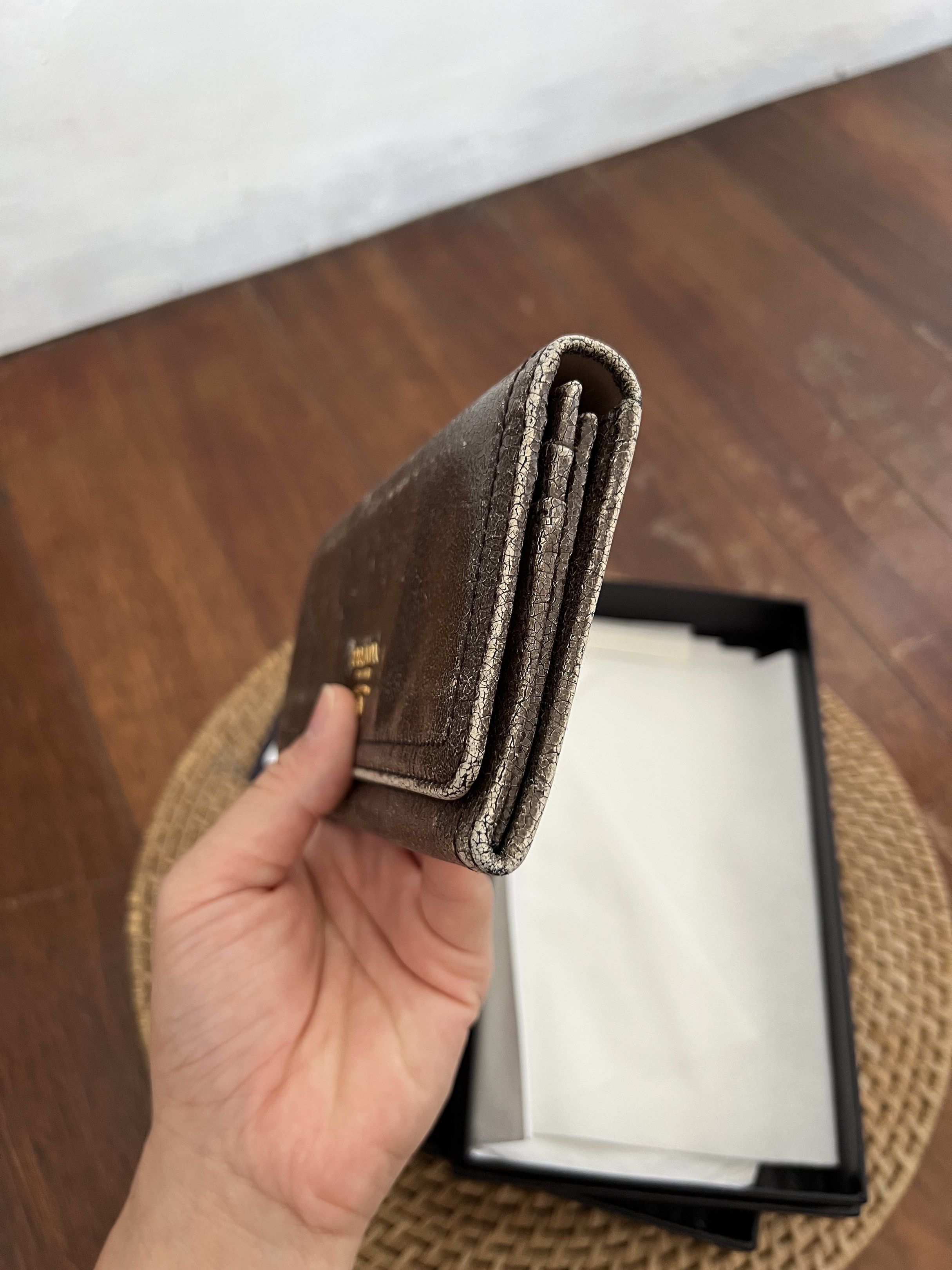 Prada Craquele Long Wallet (Category: Wallets & Card holders) located in Quezon City. Submitted by kdiv_ (Listing ID 1419093818, Image 3). Description: Personal preloved |Guaranteed Authentic Bought in Singapore Inclusions: Authenticity Card and Box Flaw: Faded leather and hardware that gave an overall vintage look RFS: Decluttering, no longer being used MOP: BDO/GCash Shipping fee to be shouldered by the buyer.