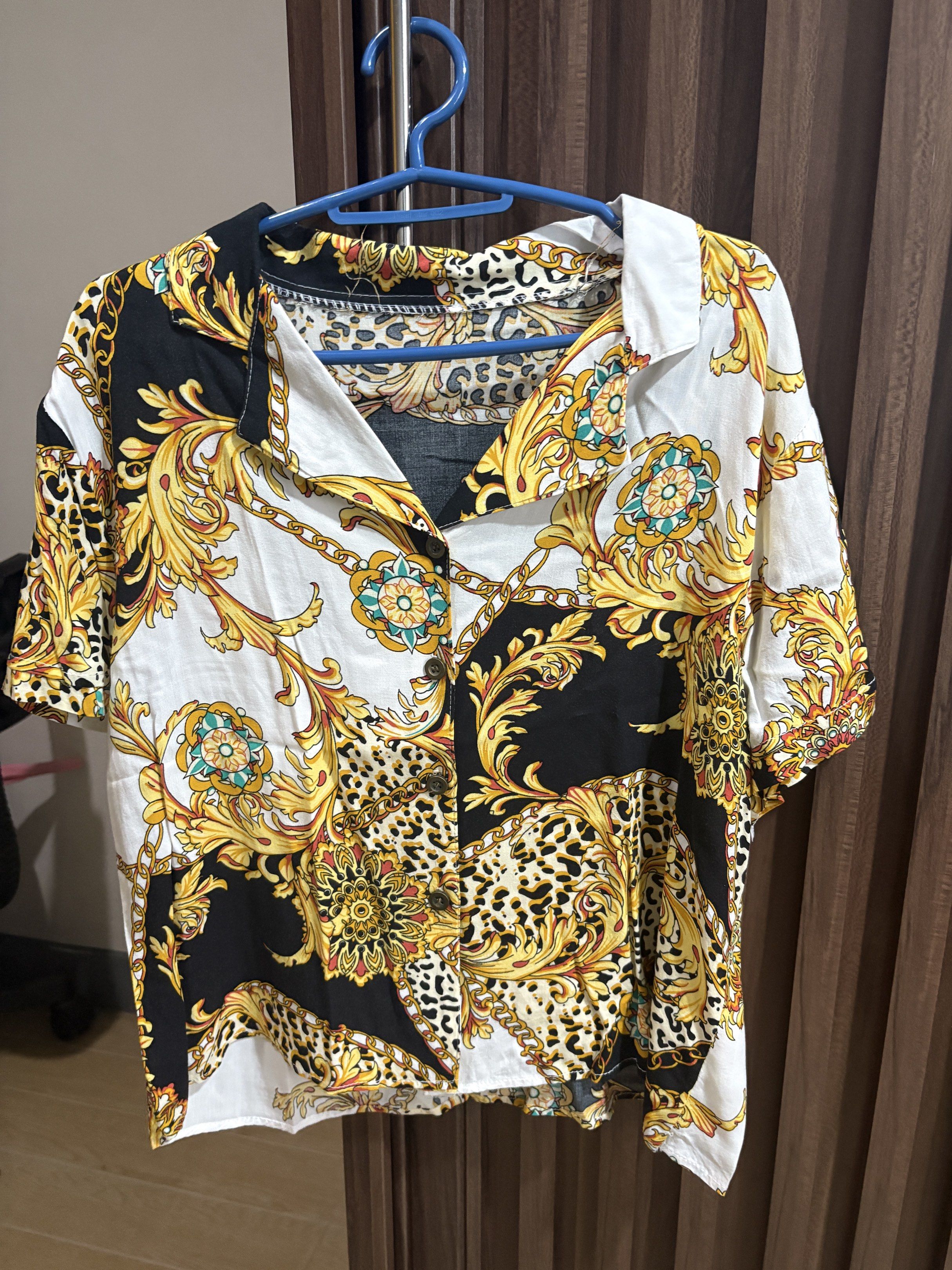 Printed Short Sleeve Shirt (Category: Shirts) located in Manila. Submitted by dkarchives (Listing ID 1419086728, Image 1). Description: Printed Short-sleeved Shirt - bought from ig shop named clothesforbreakfast - doesn’t have a size but fits Small frames - unique print with gold, black, and white patterns - button-down front - soft lightweight fabric - my fave college top!.
