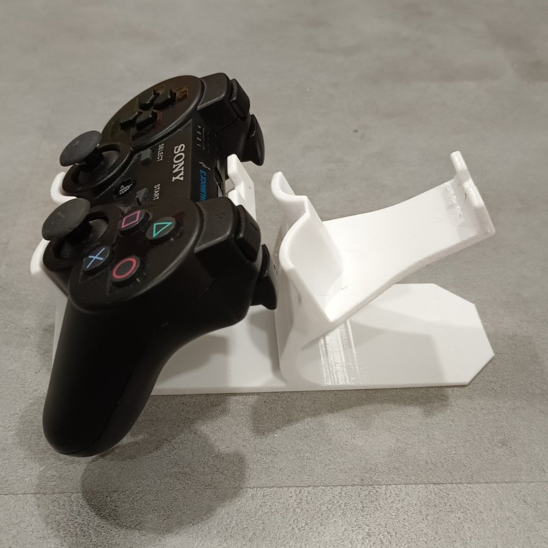 PS3 Controller Stand (Category: Controllers) located in Puchong. Submitted by elflied (Listing ID 1418992346, Image 3). Description: - PS3 controller stand (For 2 Controllers) - Features PlayStation logo - Designed for PS2 & PS3 controllers - 3D printed Material - PetG - Securely holds controller - Keeps your controllers organized and displayed. - Controller not included*.