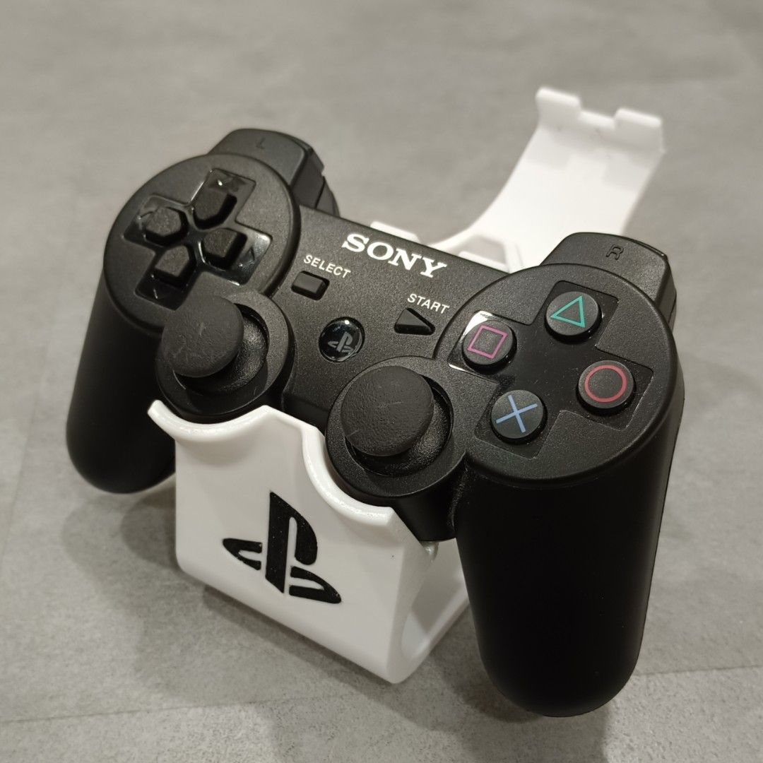 PS3 Controller Stand (Category: Controllers) located in Puchong. Submitted by elflied (Listing ID 1418992346, Image 1). Description: - PS3 controller stand (For 2 Controllers) - Features PlayStation logo - Designed for PS2 & PS3 controllers - 3D printed Material - PetG - Securely holds controller - Keeps your controllers organized and displayed. - Controller not included*.