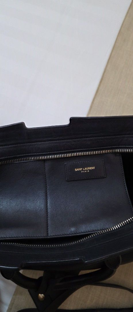 Saint Laurent YSL Black Handbag (Category: Luxury Bags & Wallets) located in Caloocan City. Submitted by mangoaddict18 (Listing ID 1419161464, Image 2). Description: - Black Saint Laurent handbag - Gold-tone hardware - Top handle and detachable shoulder strap - Interior zippered pocket - Flap closure with YSL logo - Includes detachable leather tag.