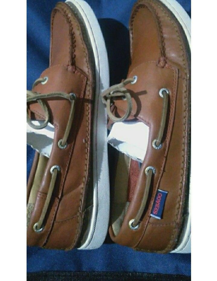 Sebago Boat Shoes (Category: Casual Shoes) located in Naga. Submitted by pec3c (Listing ID 1419086315, Image 1). Description: - Sebago boat shoes in brown leather - White soles with Sebago logo - Red soles - Leather laces - Metal eyelets - Sebago logo visible on the side - Well-maintained condition.