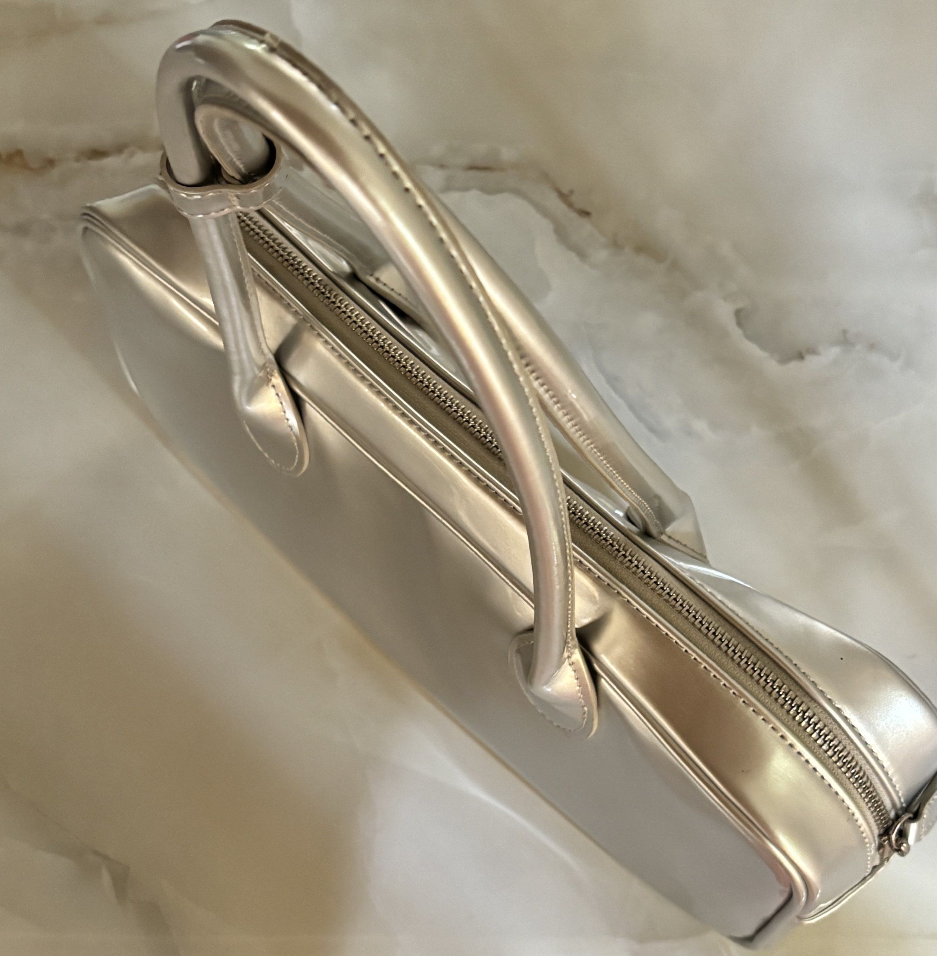 Silver Shoulder Bag (Category: Shoulder Bags) located in Batangas. Submitted by wcwonwon (Listing ID 1418998859, Image 2). Description: Silver Shoulder Bag Has minimal stains but overall good condition 8/10.